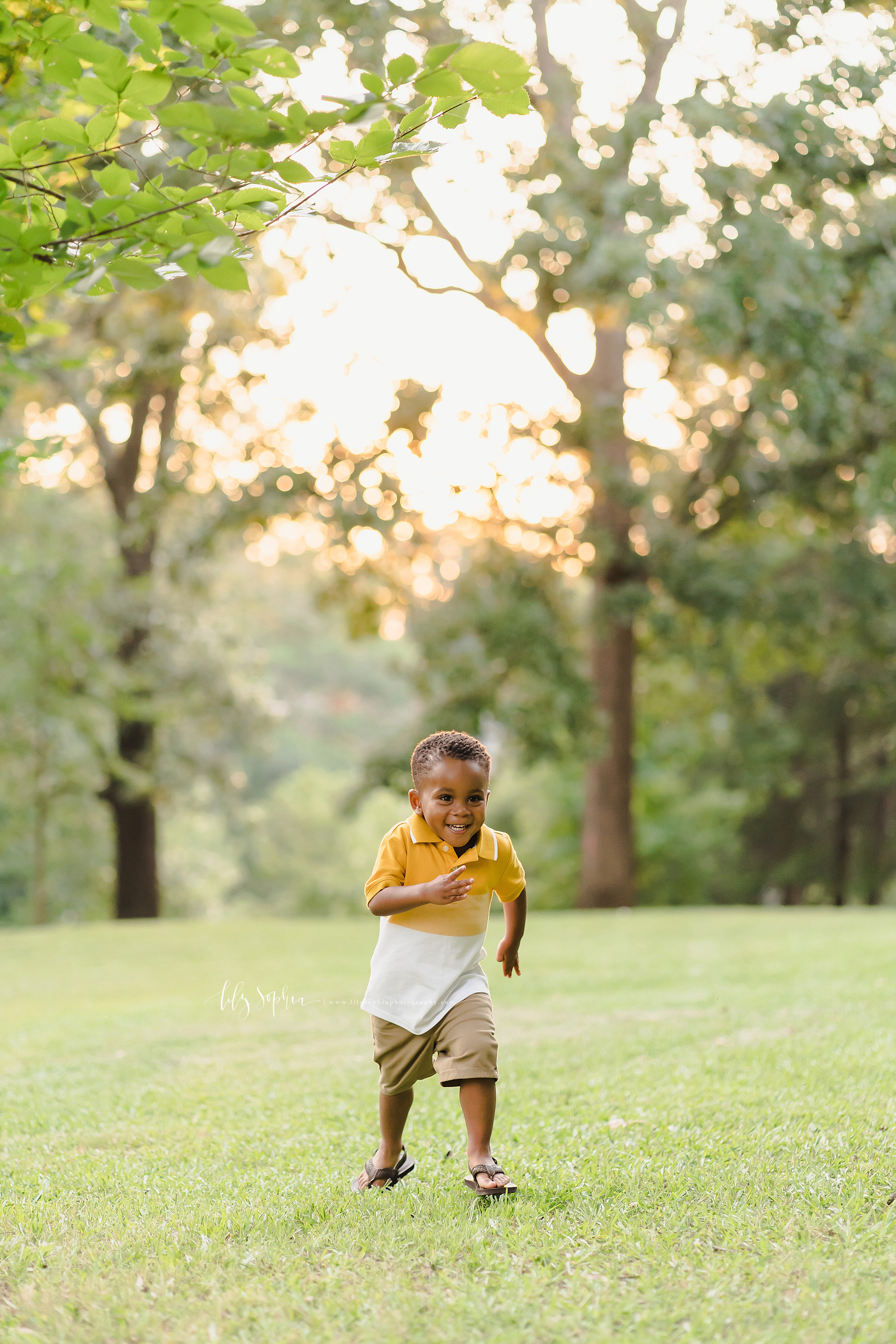  Photo of a happy African-American toddler  boy as he sprints in a park at sunset in Atlanta. 