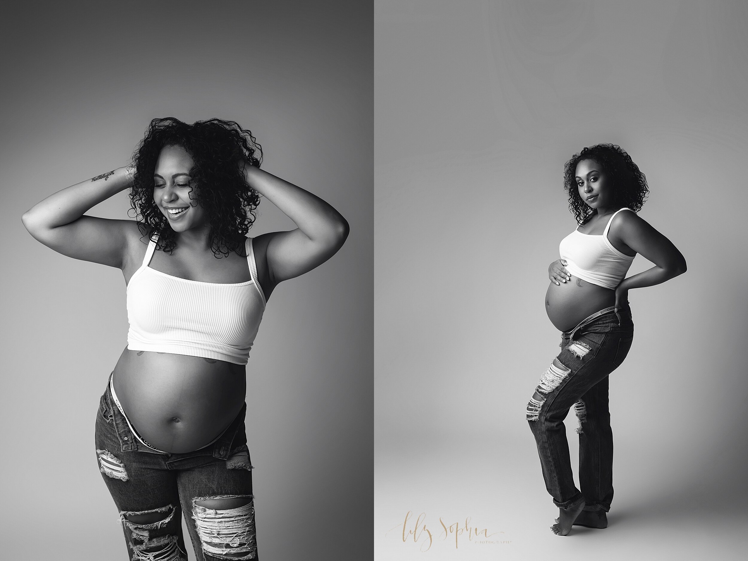  Black and white modern maternity images of happy pregnant African American female with curly hair wearing white crop top and ripped jeans taken in Atlanta, Georgia studio. 