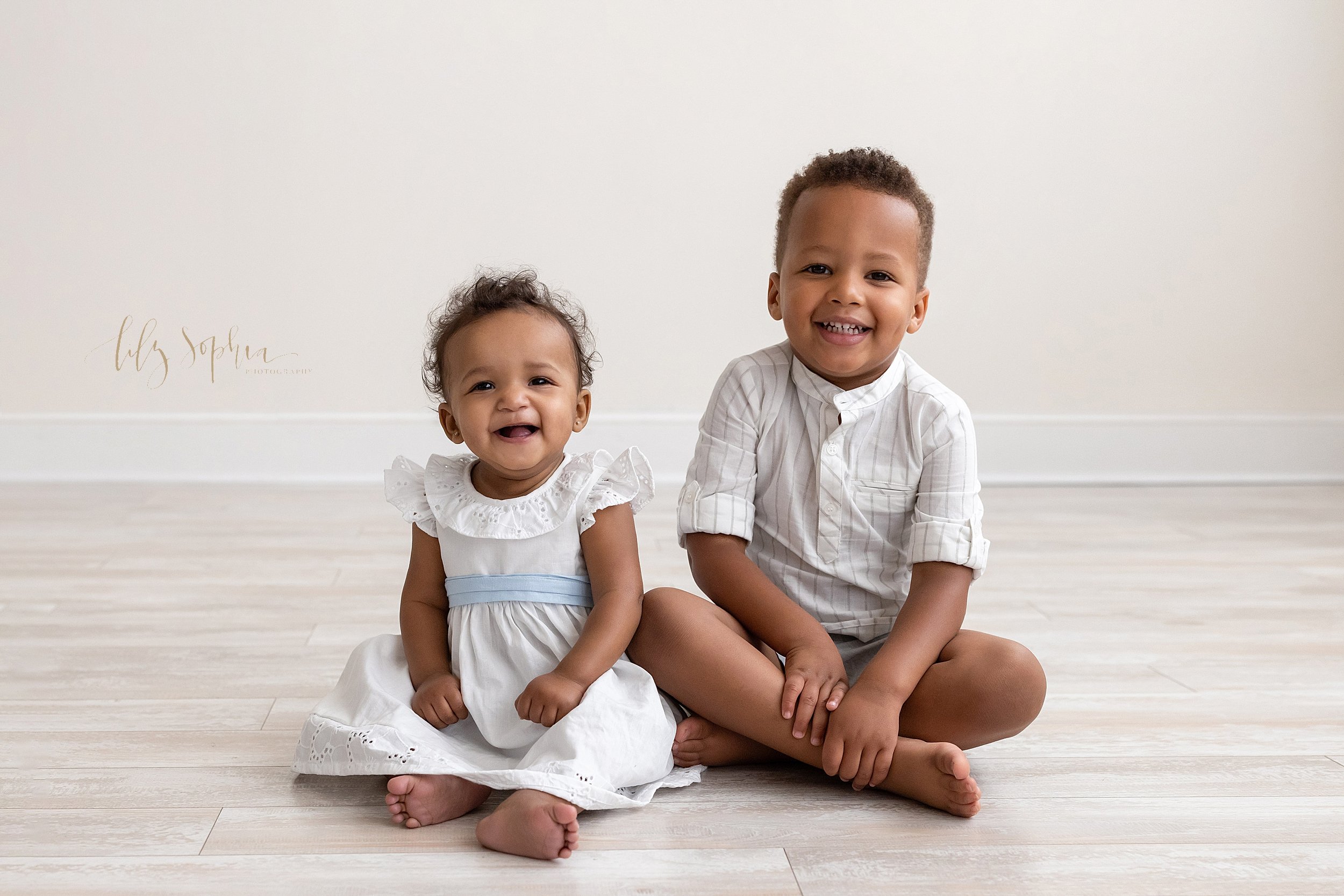  Family photo of African-American siblings as they sit on the floor of a studio near Virginia Highlands in Atlanta that uses natural light. 