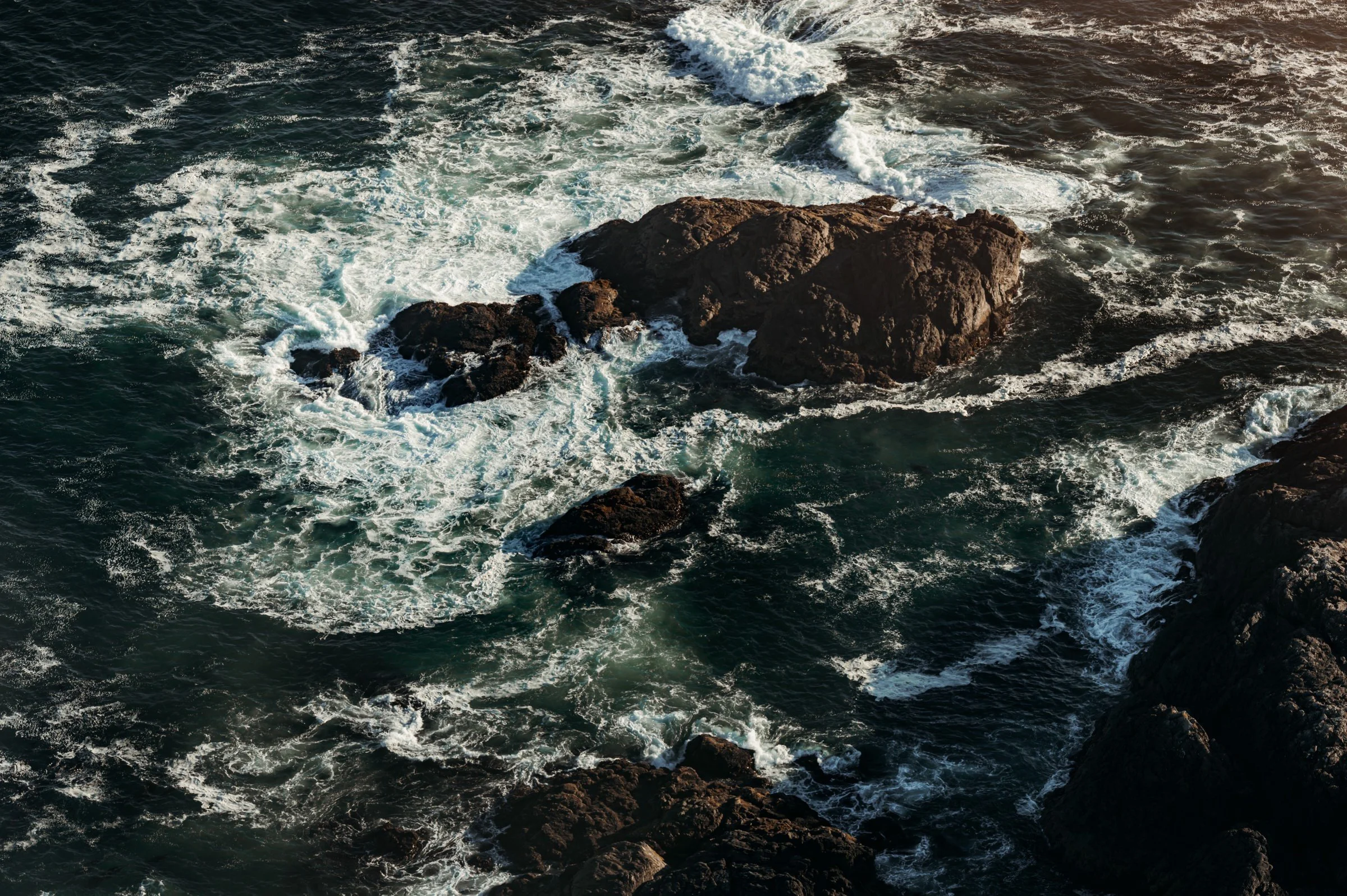 Waves crashing against rocks in the ocean