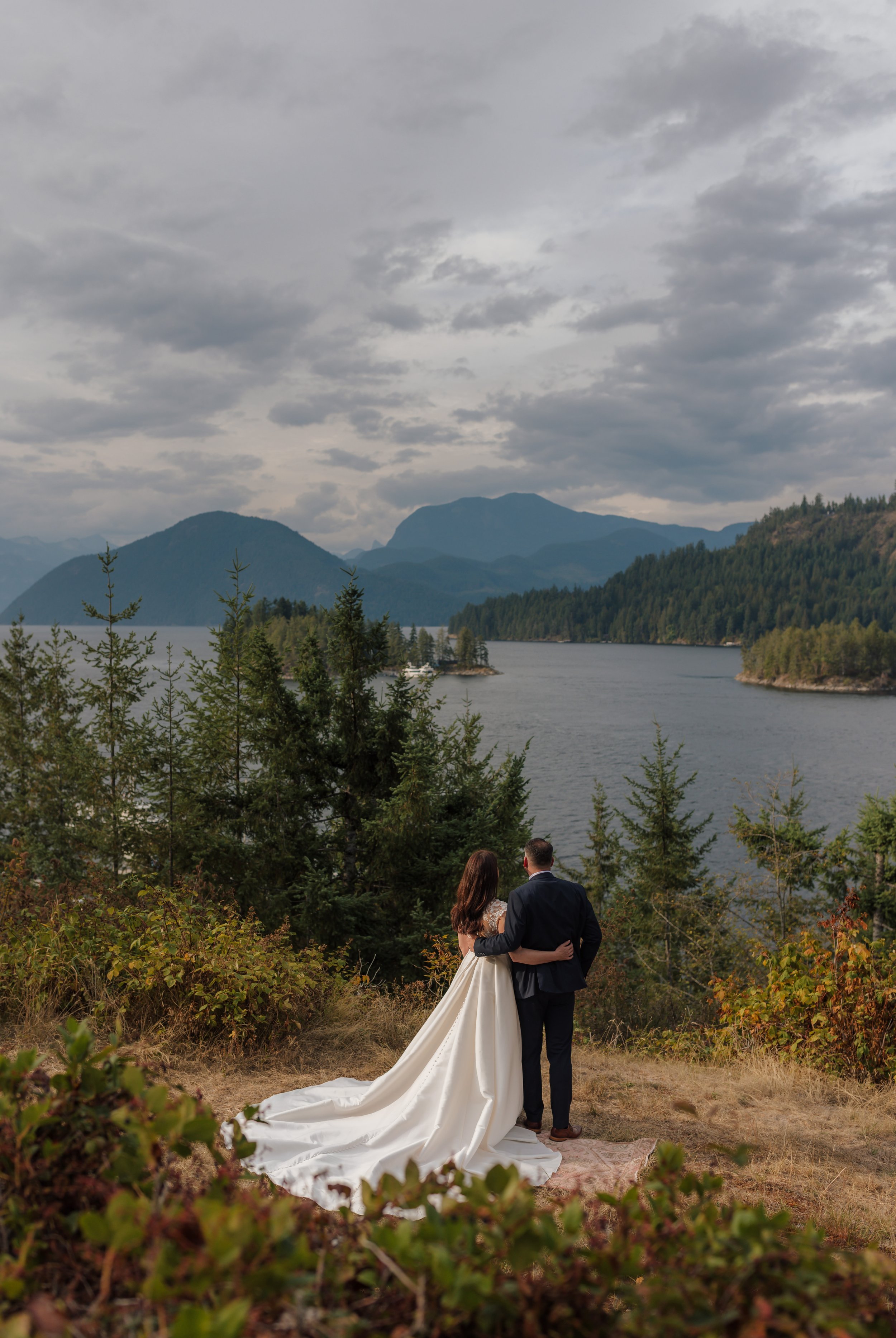 wedding couple looking out over the view at the West Coast Wilderness Lodge on the Sunshine Coast, BC