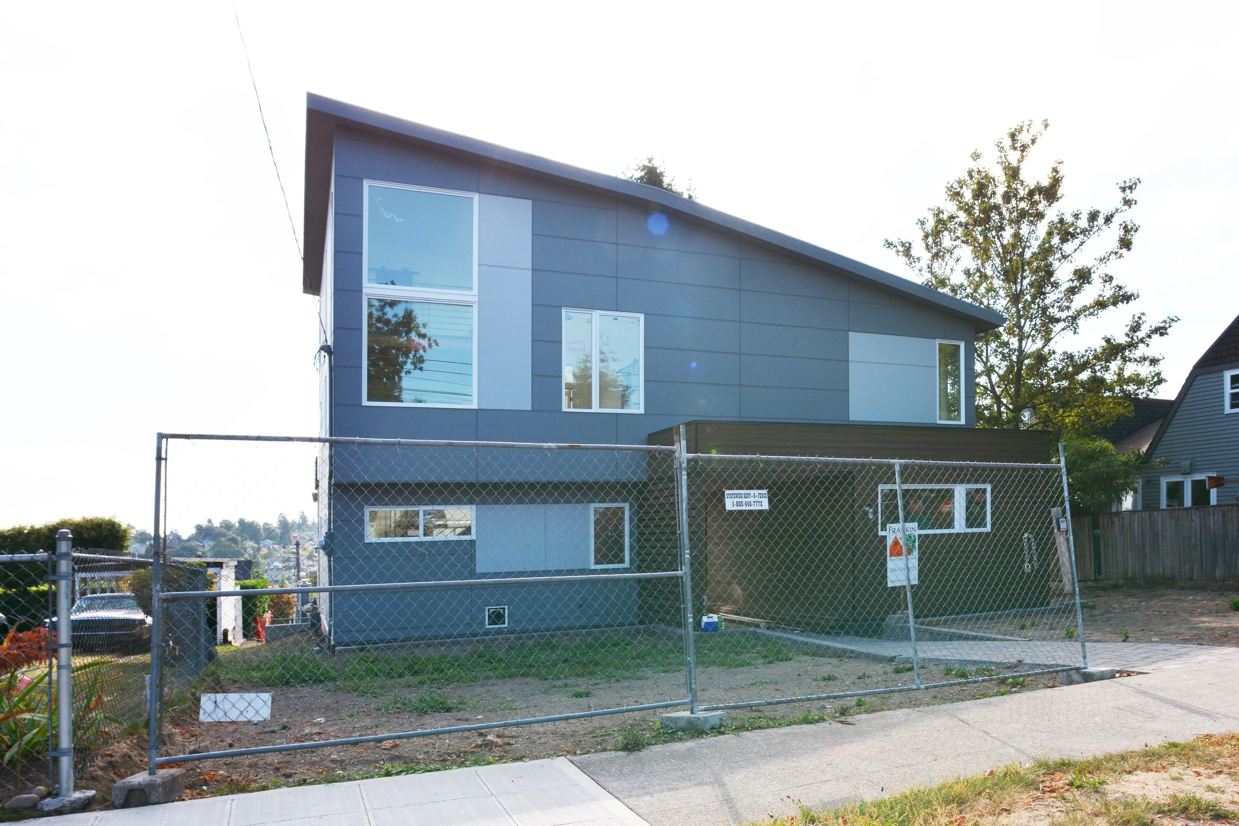 Street facade showing our major moves of the entry pathway and sloped roof to emphasis the interior vertical space