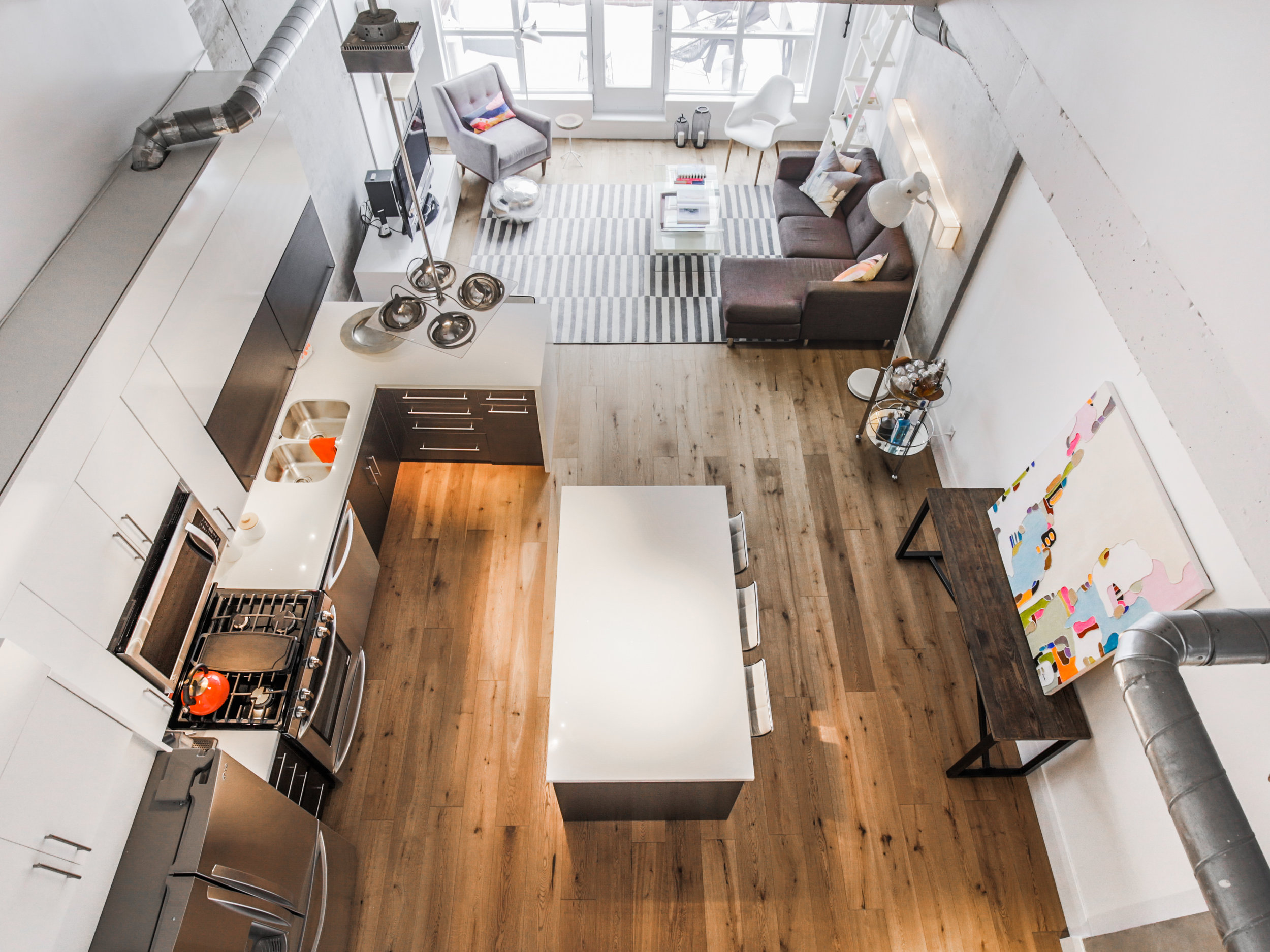 Terrace view of the main level. We wanted to compliment the height of the walls and size of the space by styling it with large, eye-catching art pieces. 