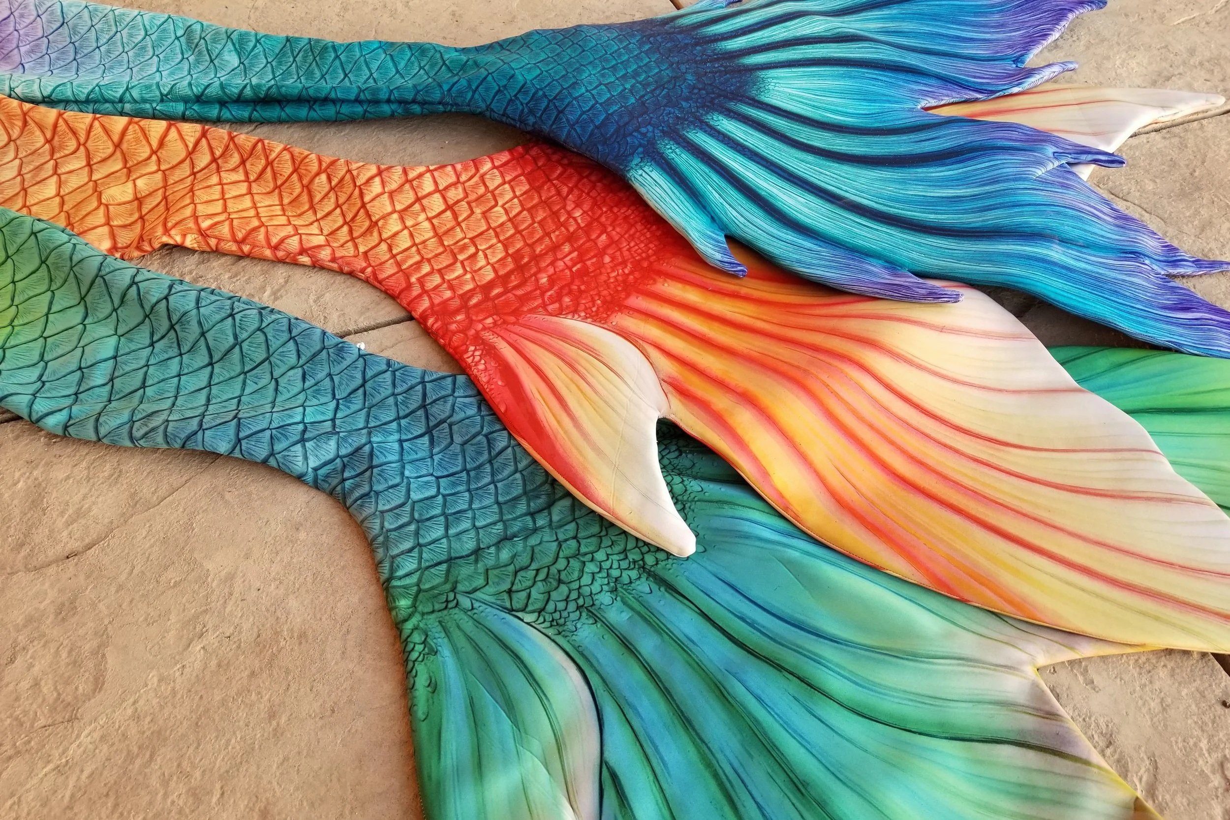 Extra Small (green), Small (orange), and Extra Small (Blue / Lilac) Neoprene Tail Options