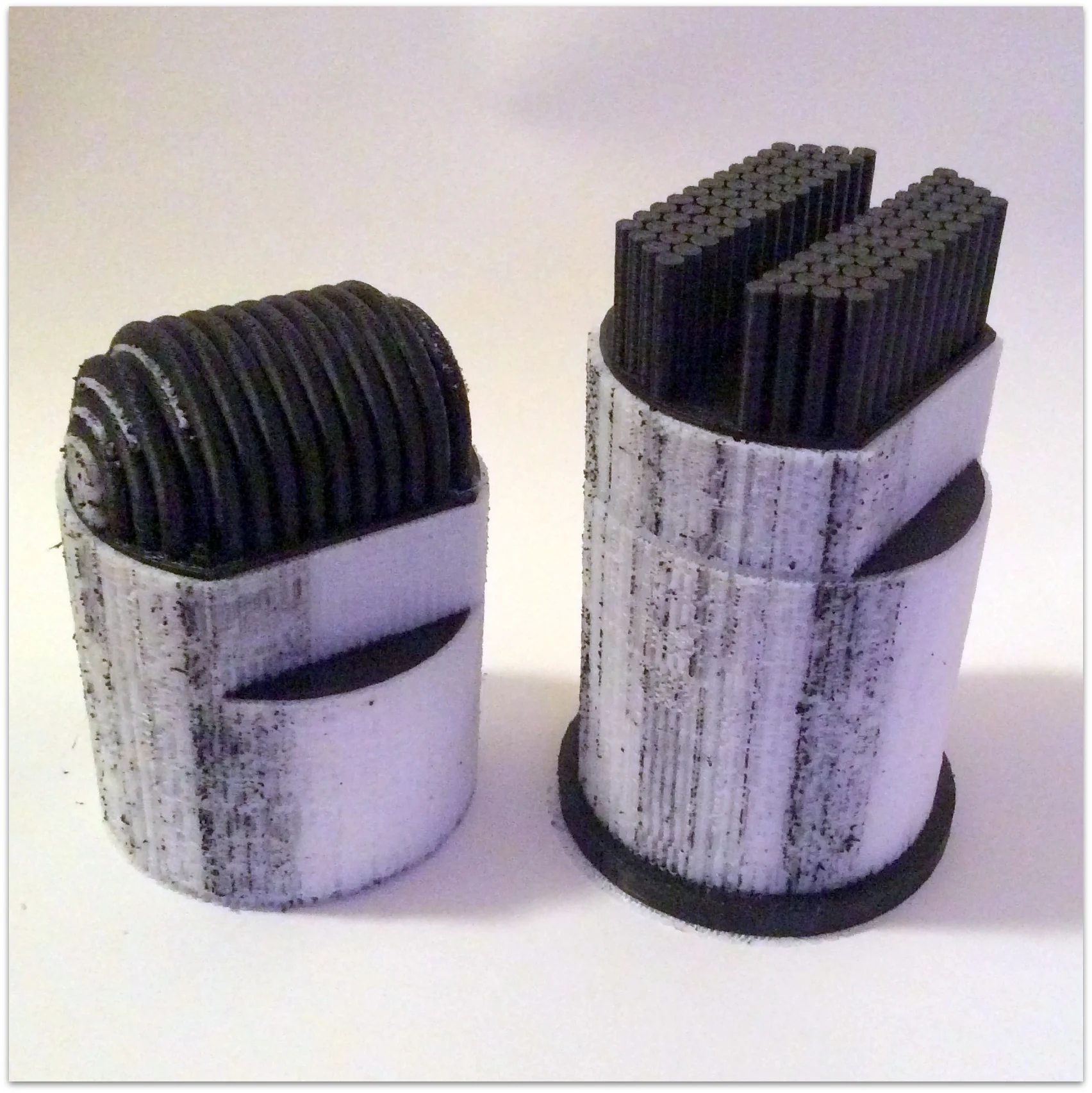 2 part print with soluble HIPS) support material (white) which will be dissolved away to leave the black model pieces.