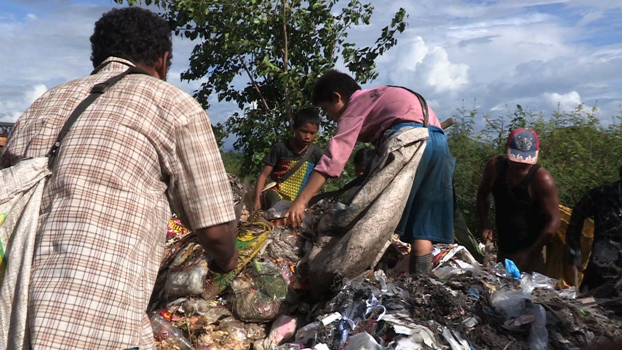Children have to work picking through garbage to supplement their family income