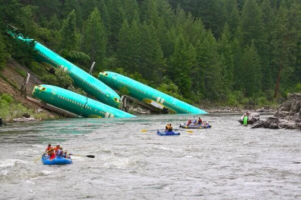 Several Boeing 737 fuselages lie in the Clark Fork River following the train derailment