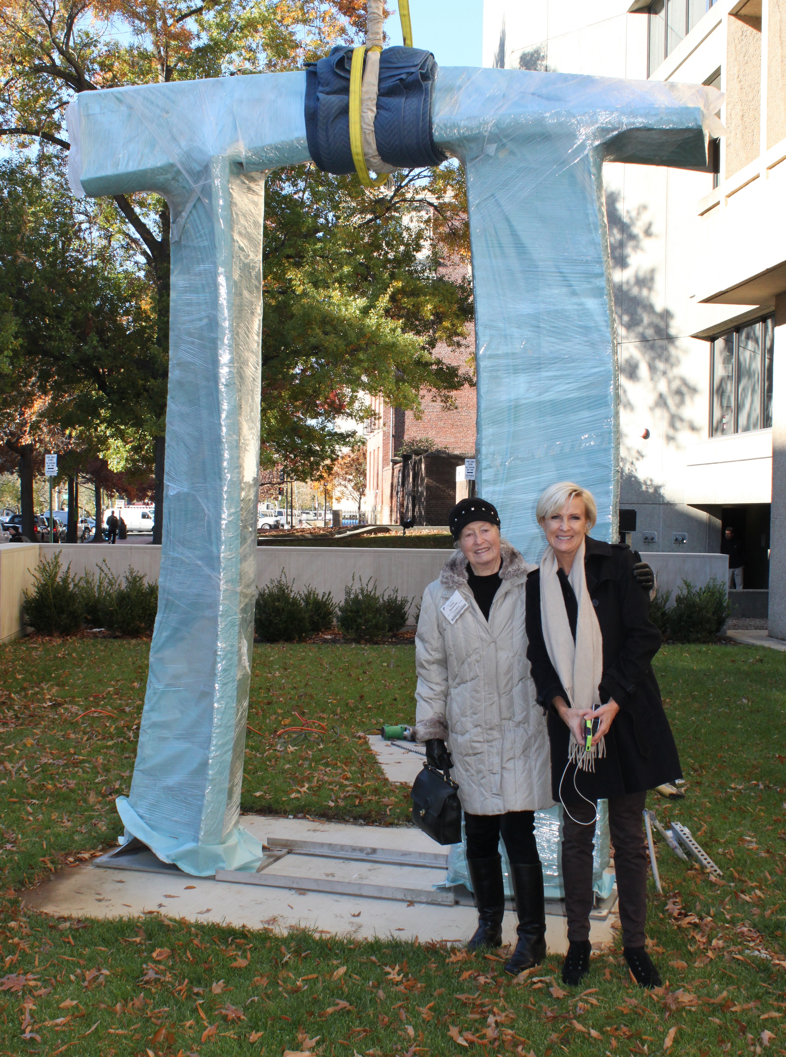  Emilie and Mika Brzezinski pose in front of Arch in Flight before it is unwrapped. 