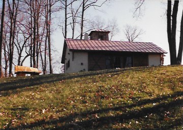 Bench in Flight I, 1994, 3'6" x 6' x 2'6", white oak. Shown outside my rural Virginia hut.