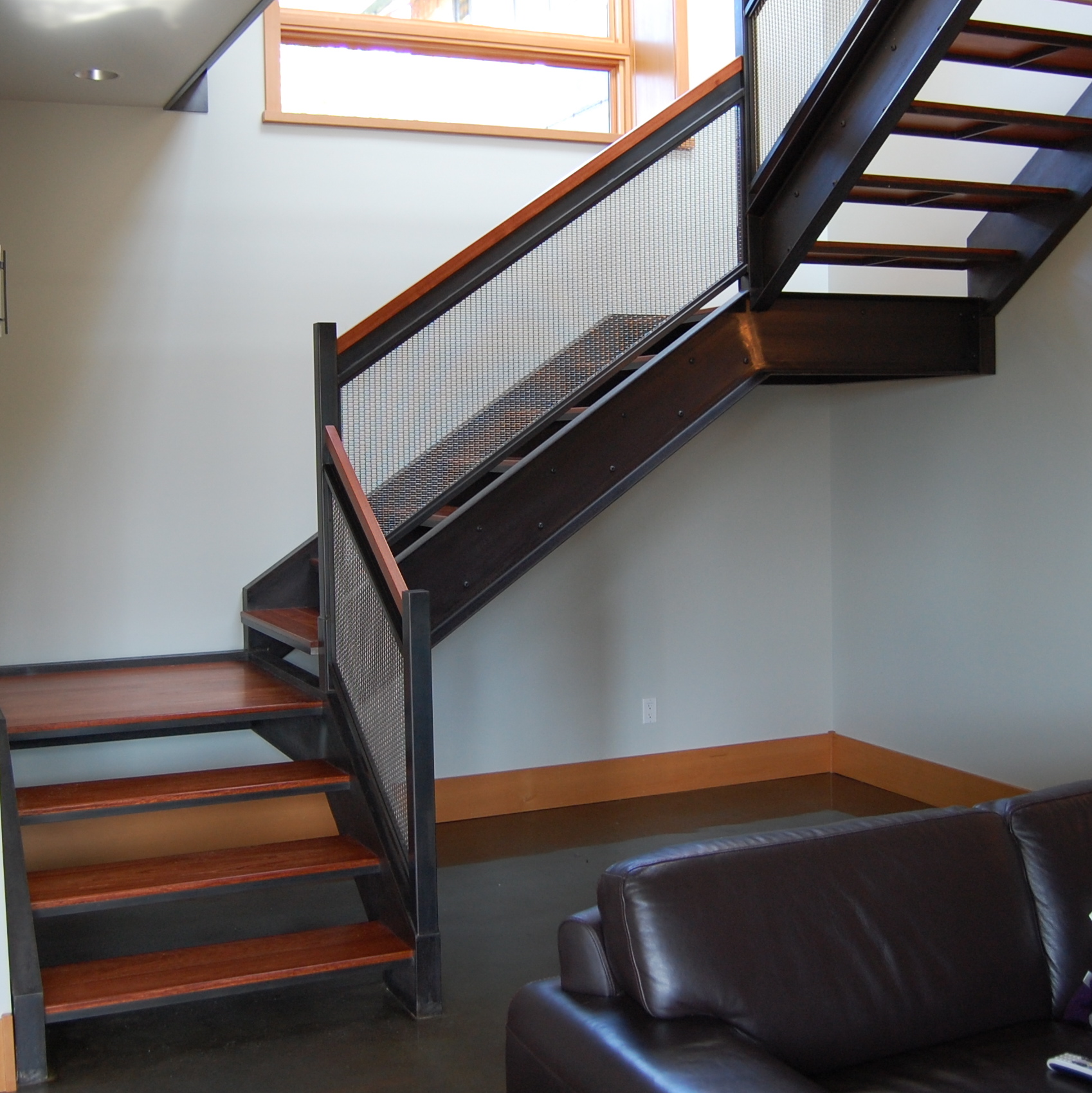  Blackened Steel staircase and railing. Infill is stainless steel woven wire mesh.  Designed by Formed Objects. 