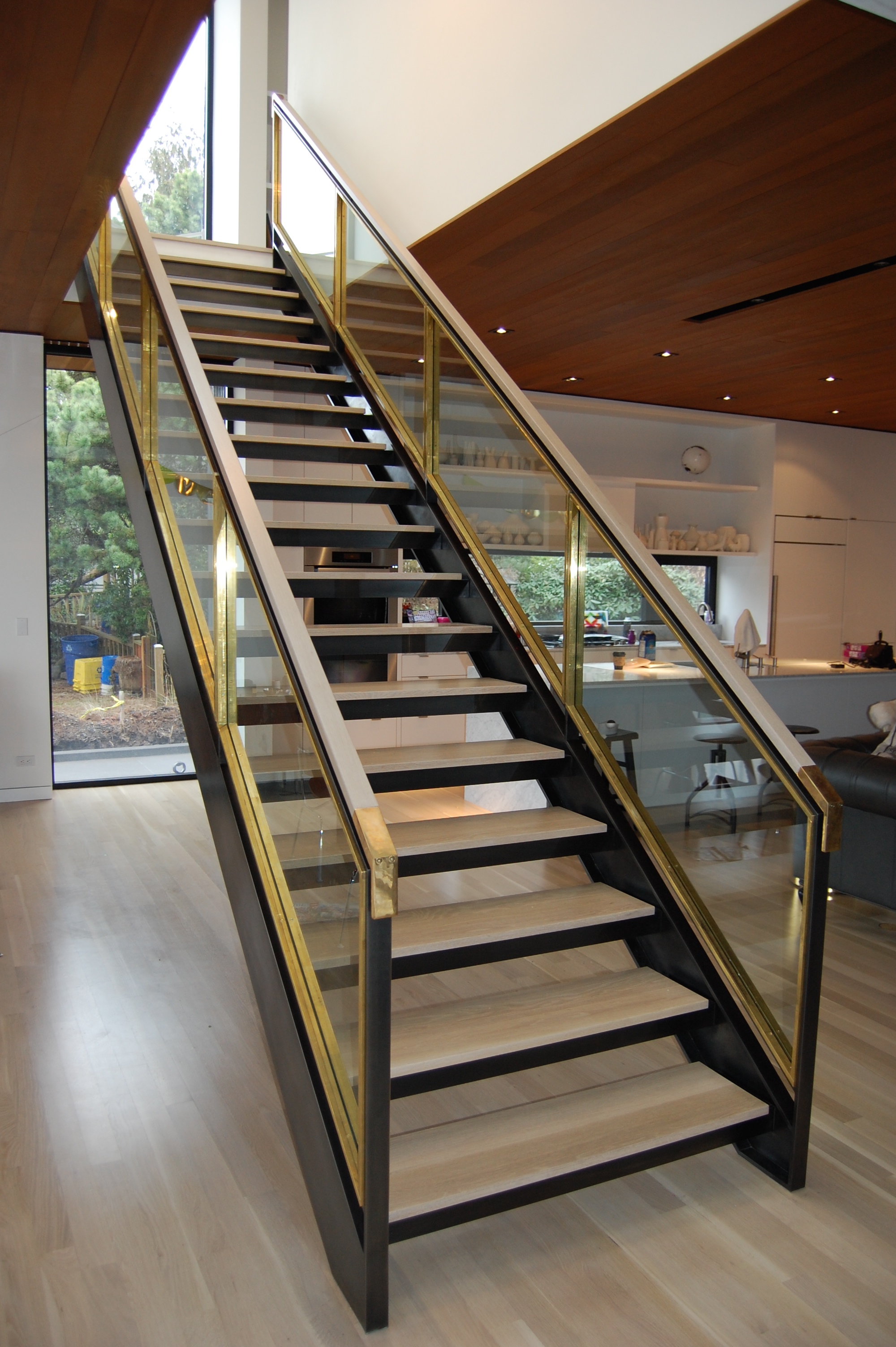  Staircase built out of blackened steel, brass and glass. Glass is stopped in on both sides with solid brass flat bar. Sides&nbsp;are fabricated channel with fully welded seams that were ground and sanded. &nbsp;Solid brass handrail ends transition i