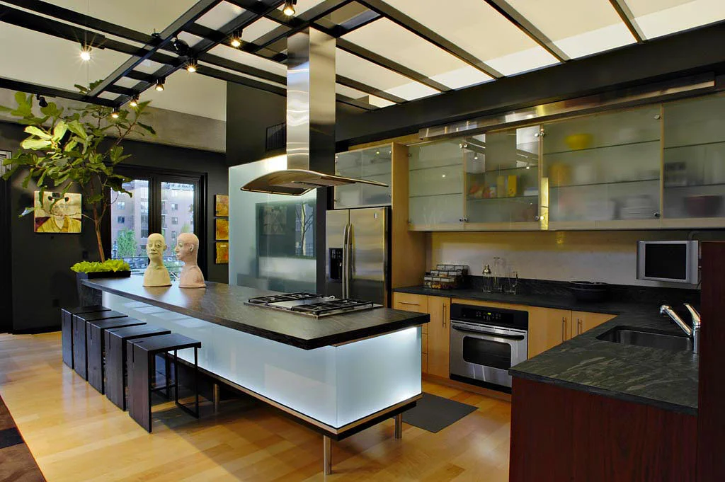 Kitchen Roof Structure is painted steel with brushed stainless infill. Island is brushed stainless. Hood exhaust is brushed stainless. Designed by Jeff Lamb