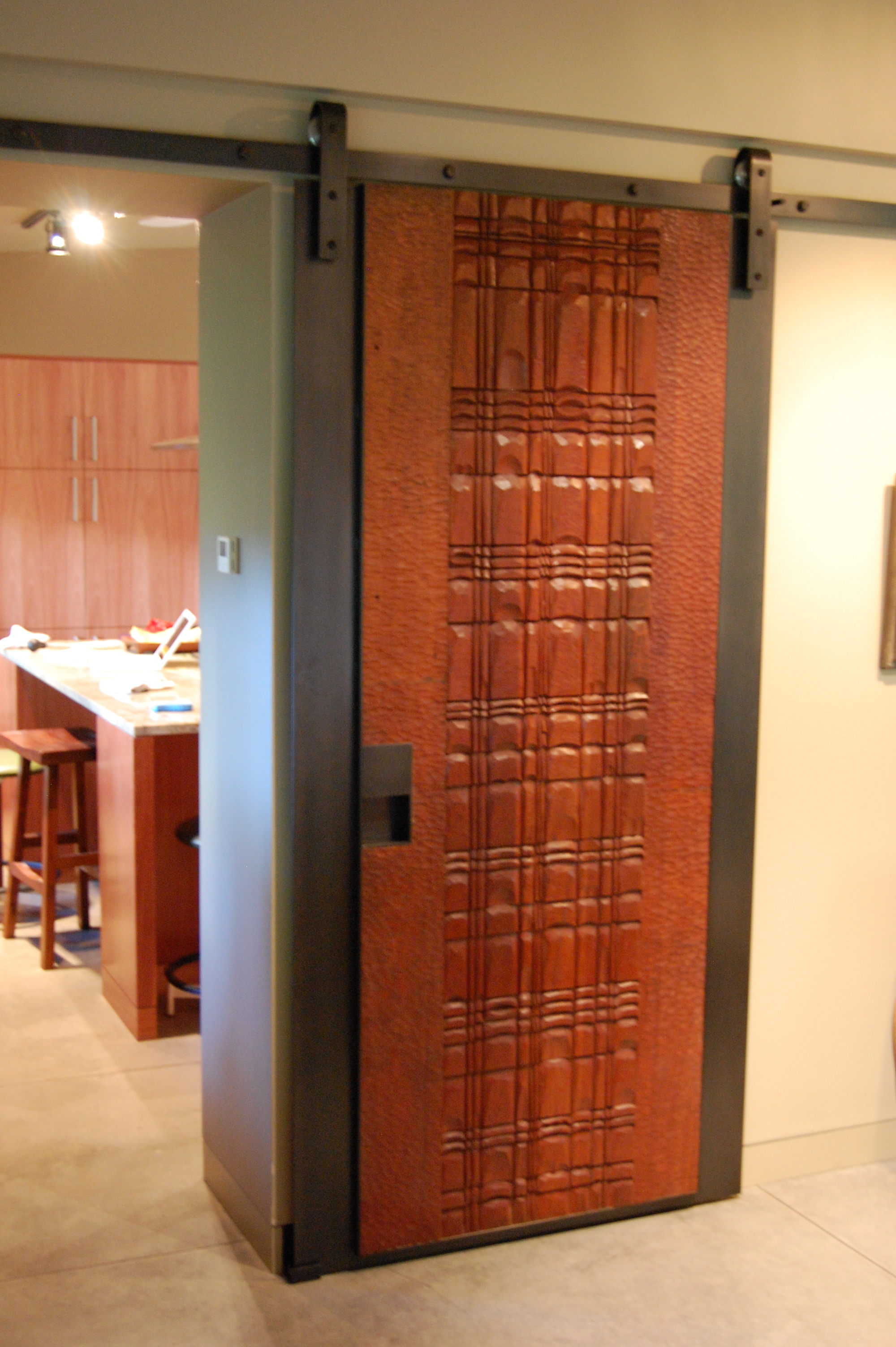  Steel track and wrapping a wood carved door with steel. Also produced a double sided handle. Wood was provided by the homeowner.  Designed by Eggleston/Farkas Architects&nbsp; 