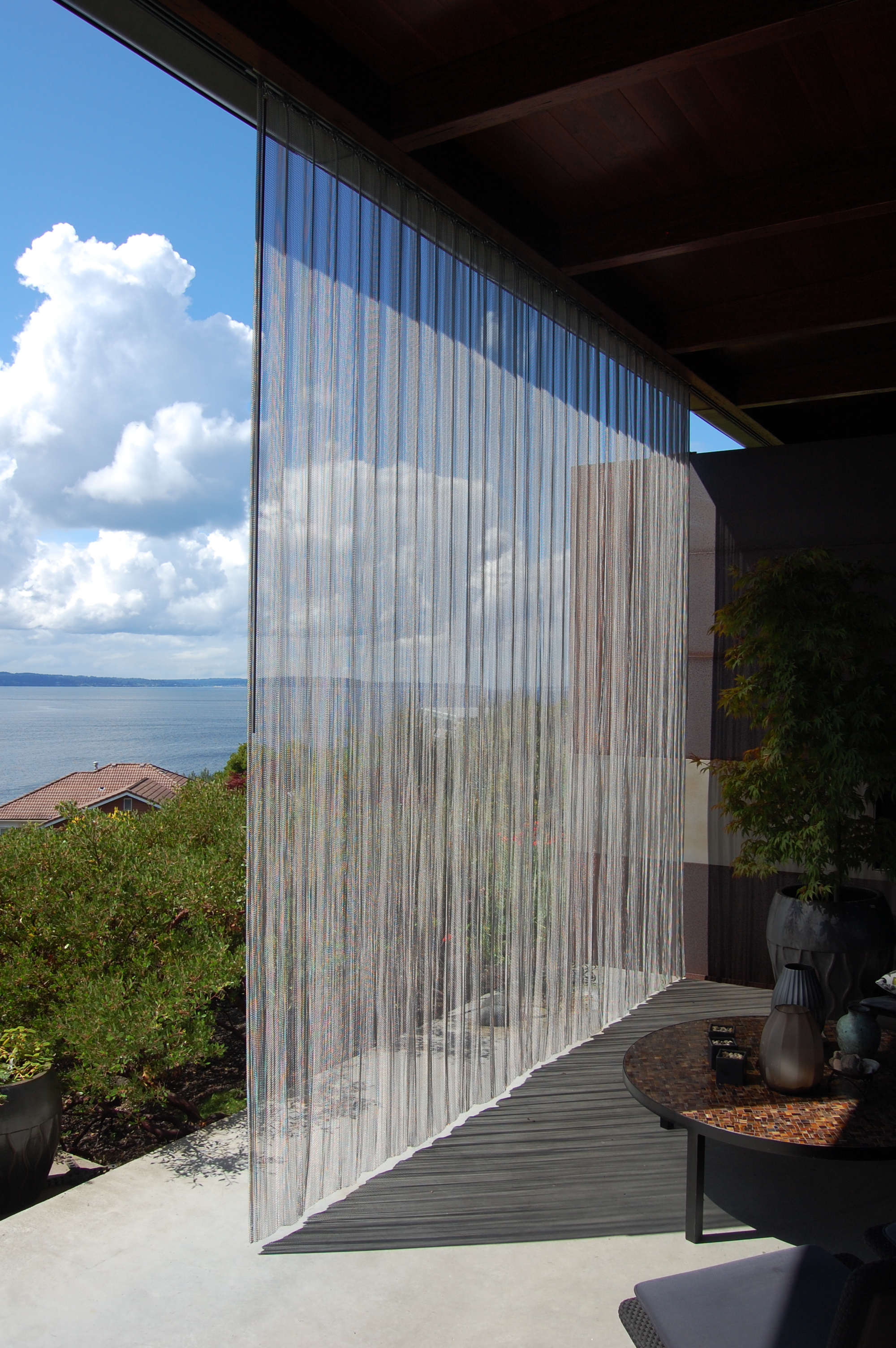  Woven stainless steel screen on a track.  Designed by Eggleston/Farkas Architects 