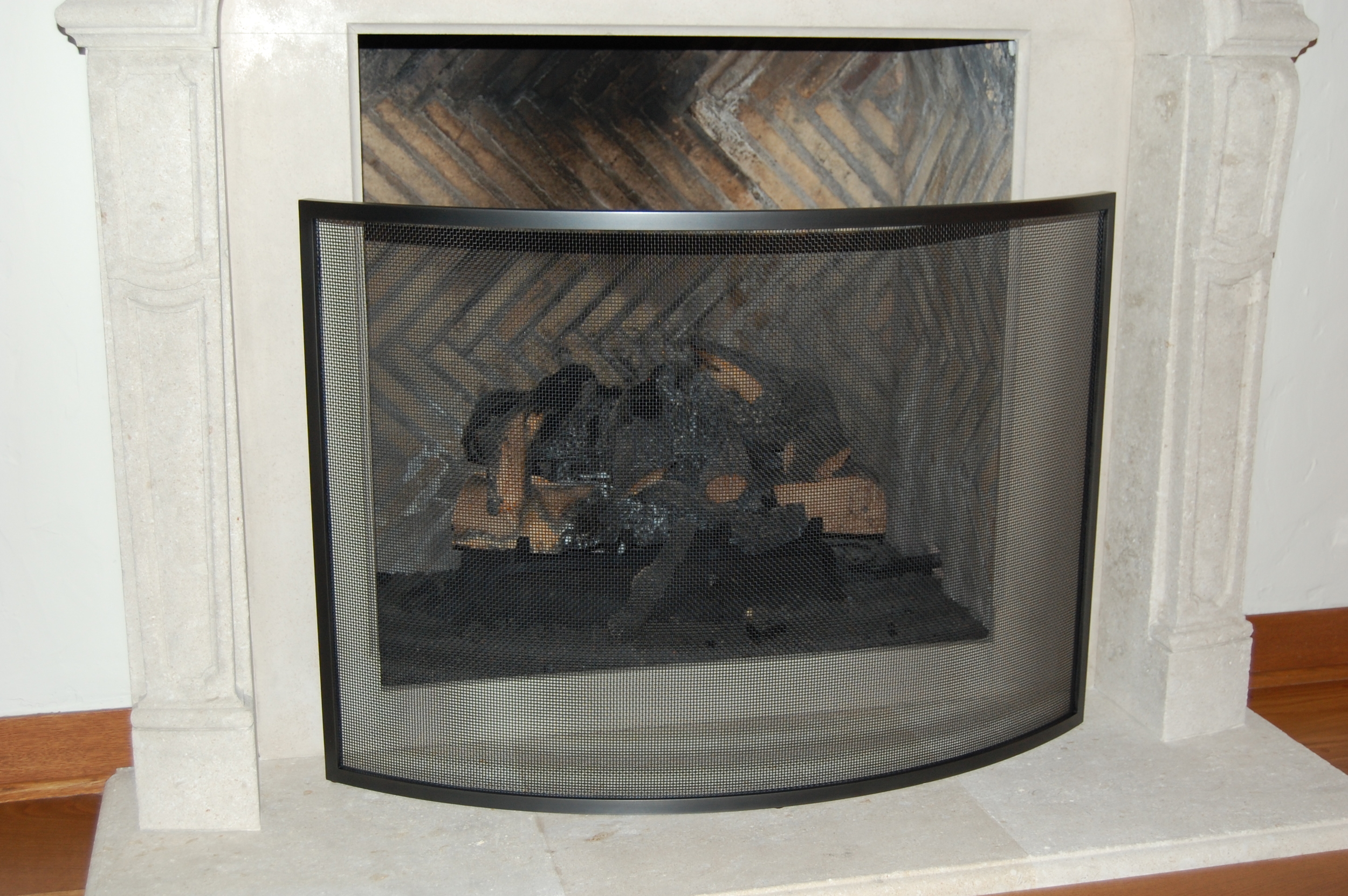  Fire screen built out of blackened steel.  Designed by Formed Objects 