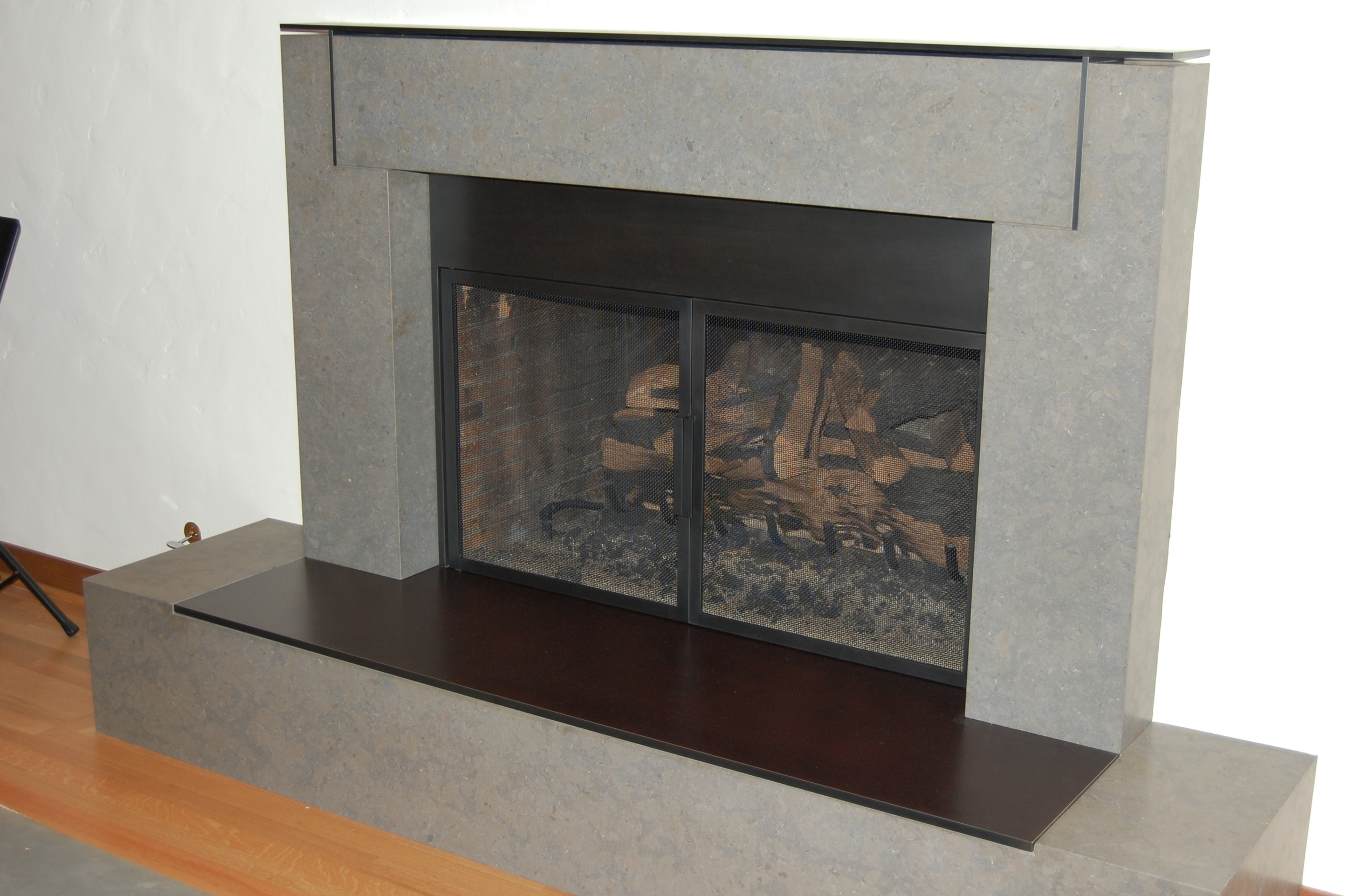  Fireplace doors, mantel&nbsp;and hearth. All out of steel.  Designed by Stuart Silk Architecture 