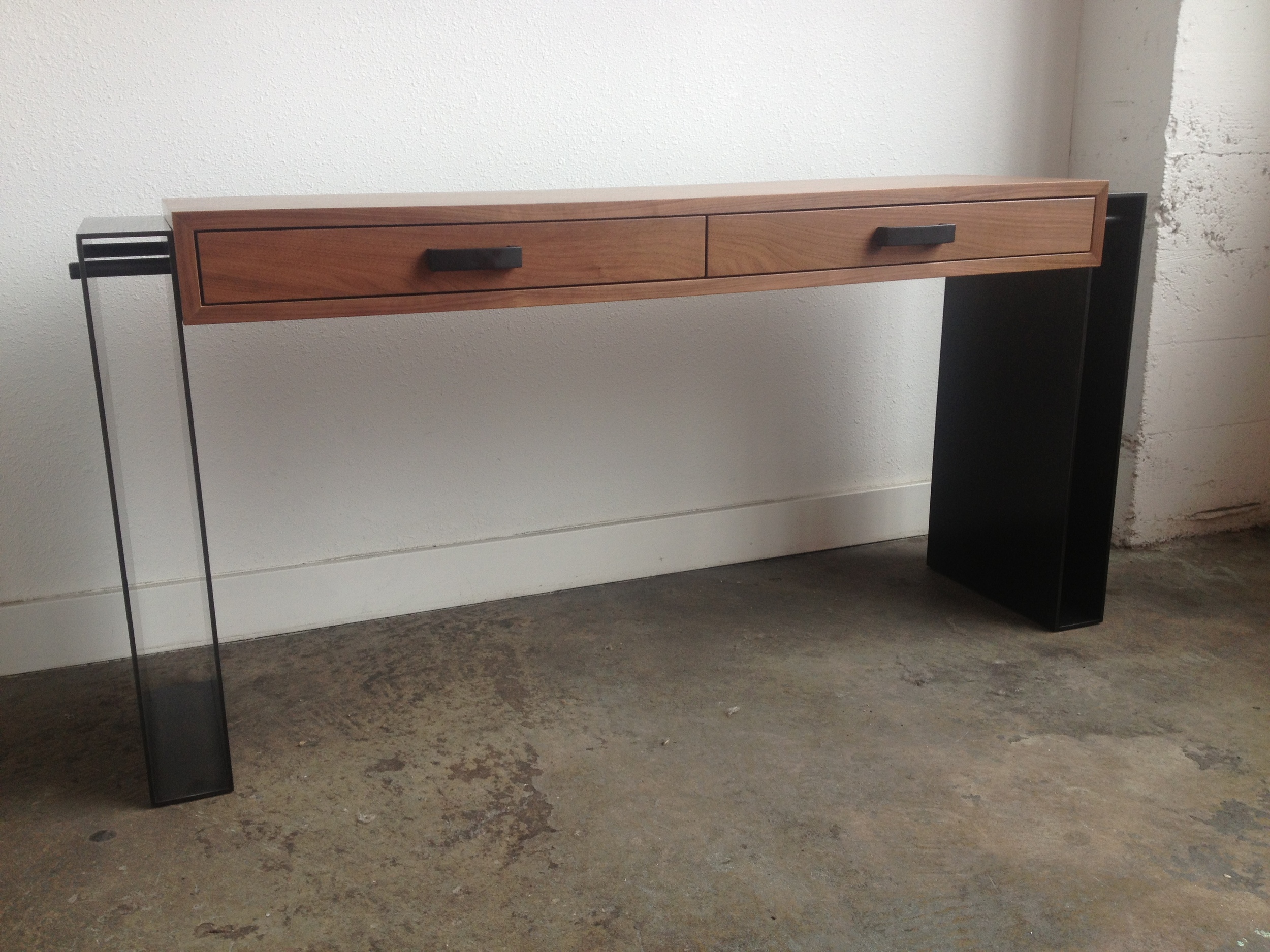  Hot Rolled Steel legs that's bolted into a Walnut Cabinet.  Designed by Hensel Design Studios 