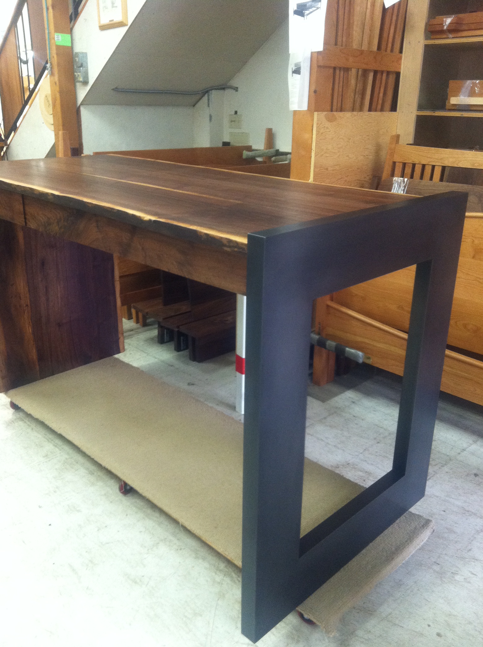  This blackened steel leg is attached to a live edge desk. Wood done by The Joinery.  Designed by The Joinery 
