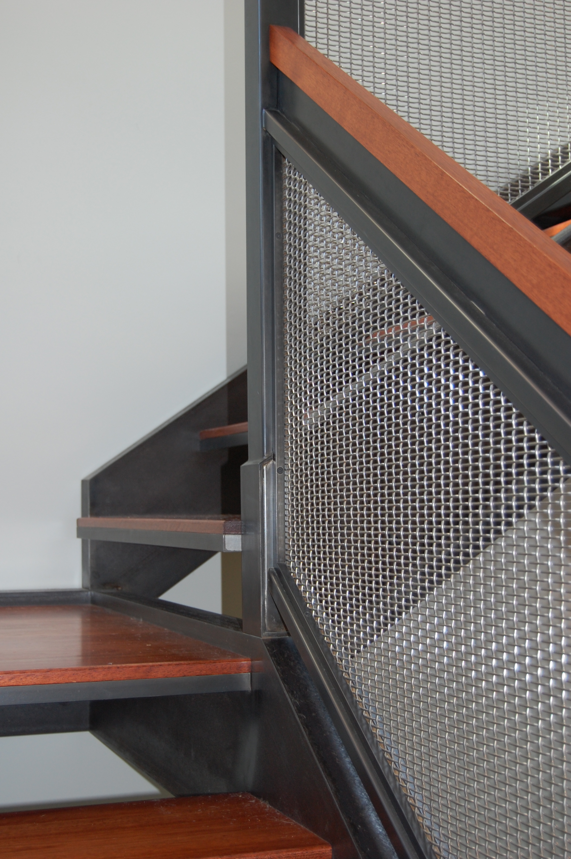  Blackened steel railing with stainless woven wire mesh.  Designed by Formed Objects 