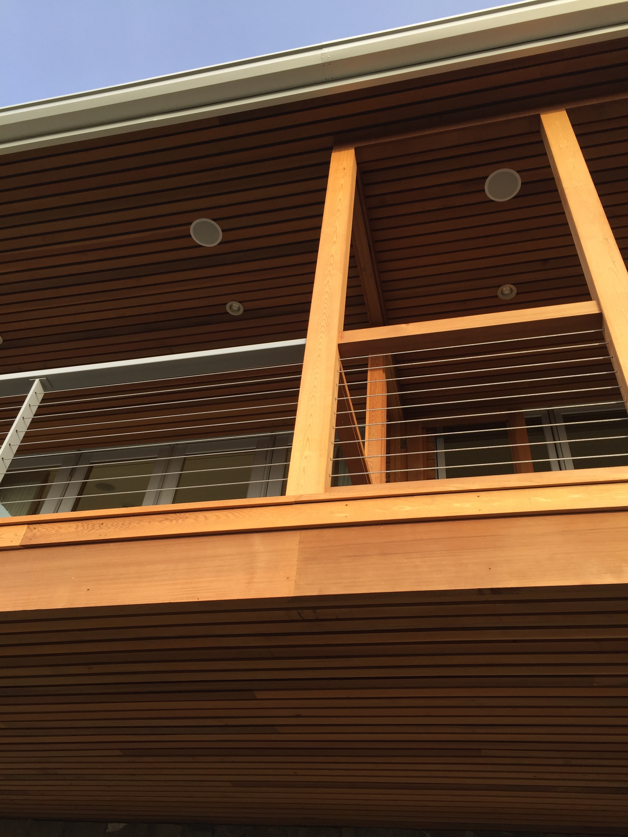  Steel railing that transitions into a wood screen porch. Cable carries through.  Designed by Pete Retondo Architecture 