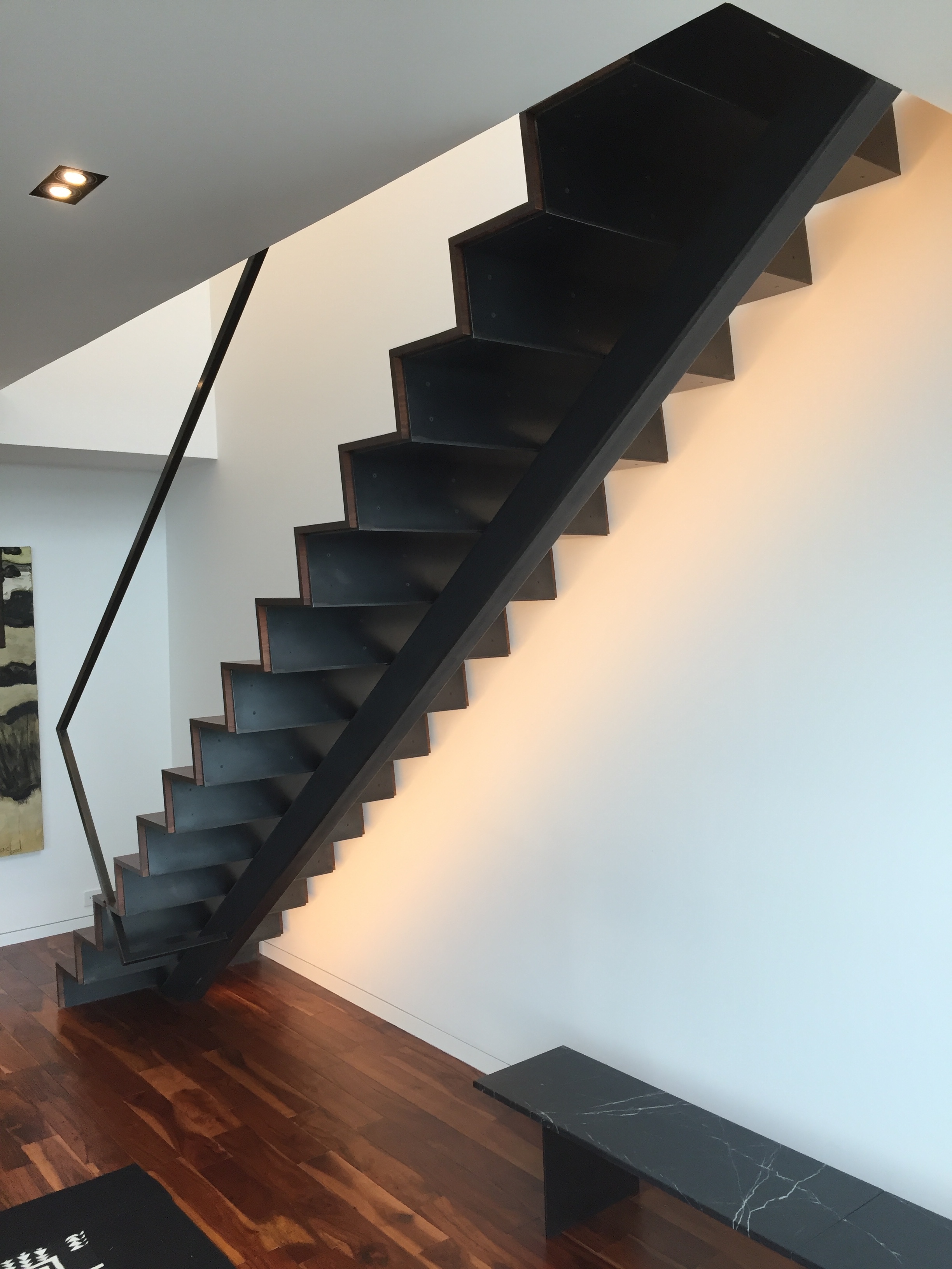  A folded steel staircase with a tube steel spine.  Designed by Paul McKean Architects 