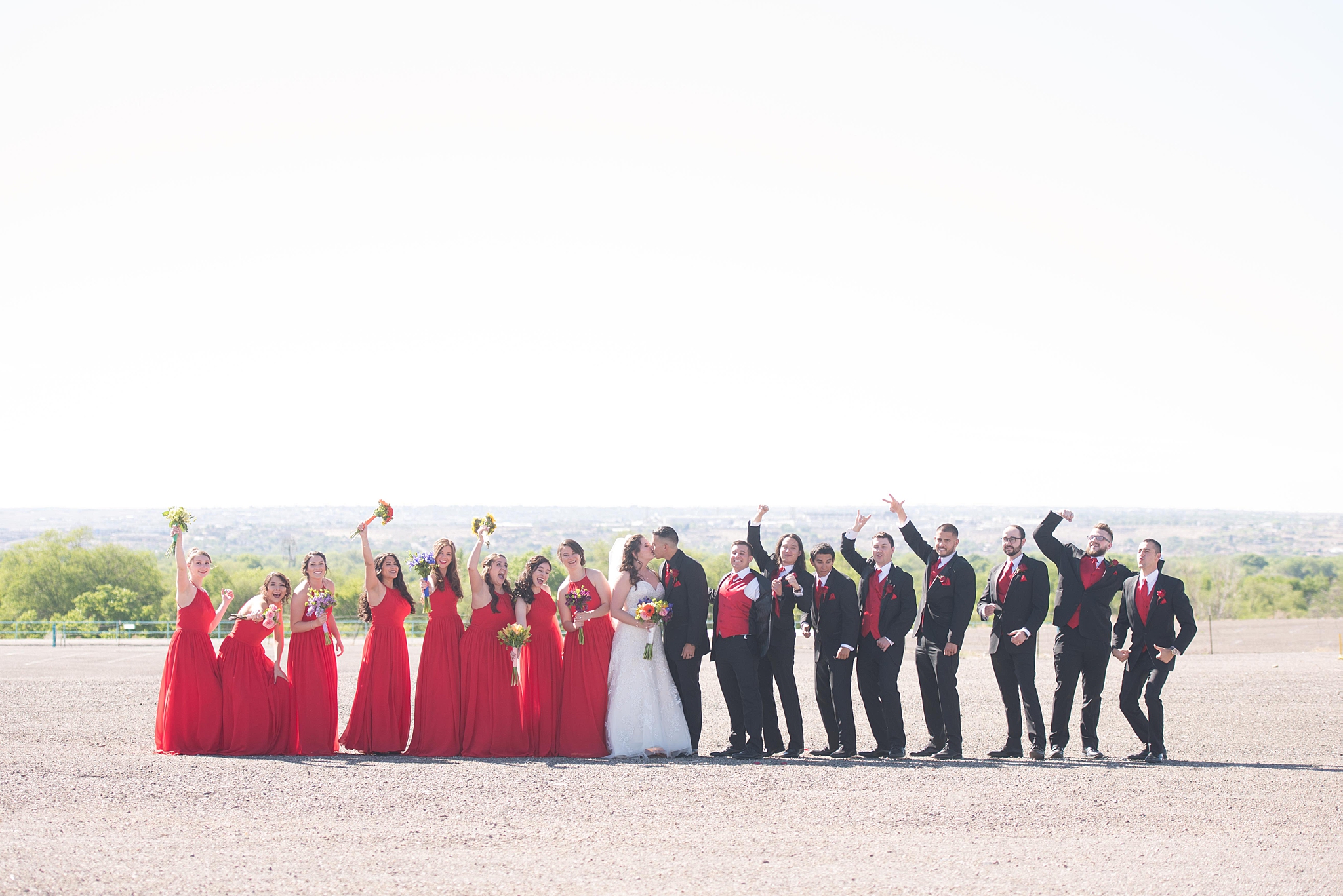 Balloon fiesta wedding with large wedding party in albuquerque new mexico. Dress by Bridal Elegance by Darlene and jewelry by enchanted jewelers. Albuquerque Wedding Photographer.
