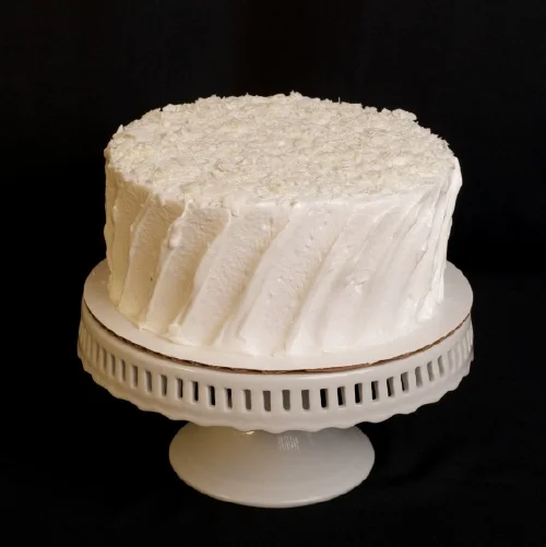 Coconut Two layers of coconut cake filled with vanilla butter cream and flaked coconut; topped with 7 minute frosting and shredded coconut. 6" (serves 8): $28 | 8" (serves 15): $42 | 10" (serves 25): $55 12" (serves 35): $75 | half-sheet (serves 55): $95 available year round