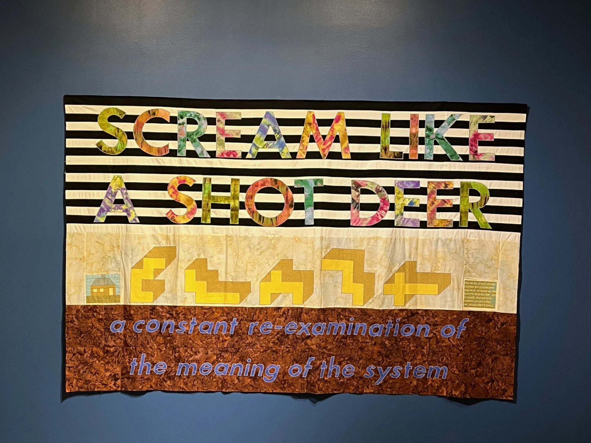   Richard Boulet  (Edmonton, AB)    Scream Like a Shot Deer    Textile, quilting, appliqué, cross stitch  162.6 x 254.0 cm  2005  Collection of Nickle Galleries, University of Calgary; Gift of the Artist 