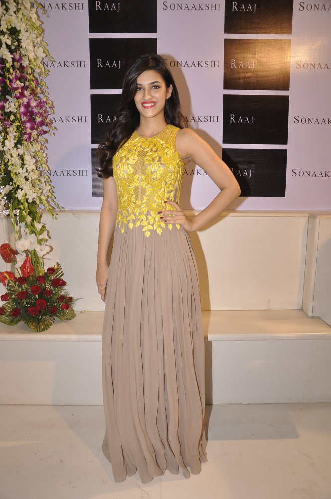 Kriti Sanon in an oyster palazzo jumpsuit with lemon yellow intricate bead-work detail.