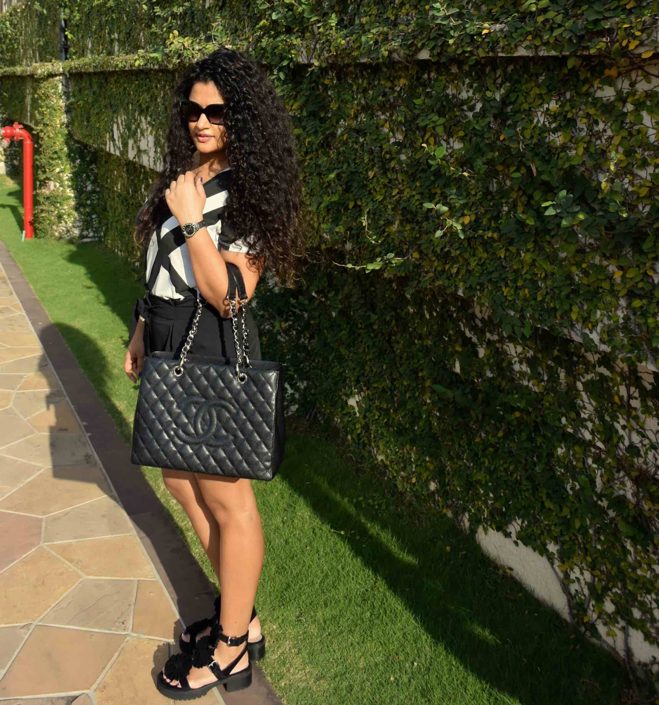 Shorts - Asos, T-shirt - Armani Exchange, Bag - Chanel, Sandals - Chloe for Opening Ceremony, Watch - Dior & Sunglasses - Chanel. 