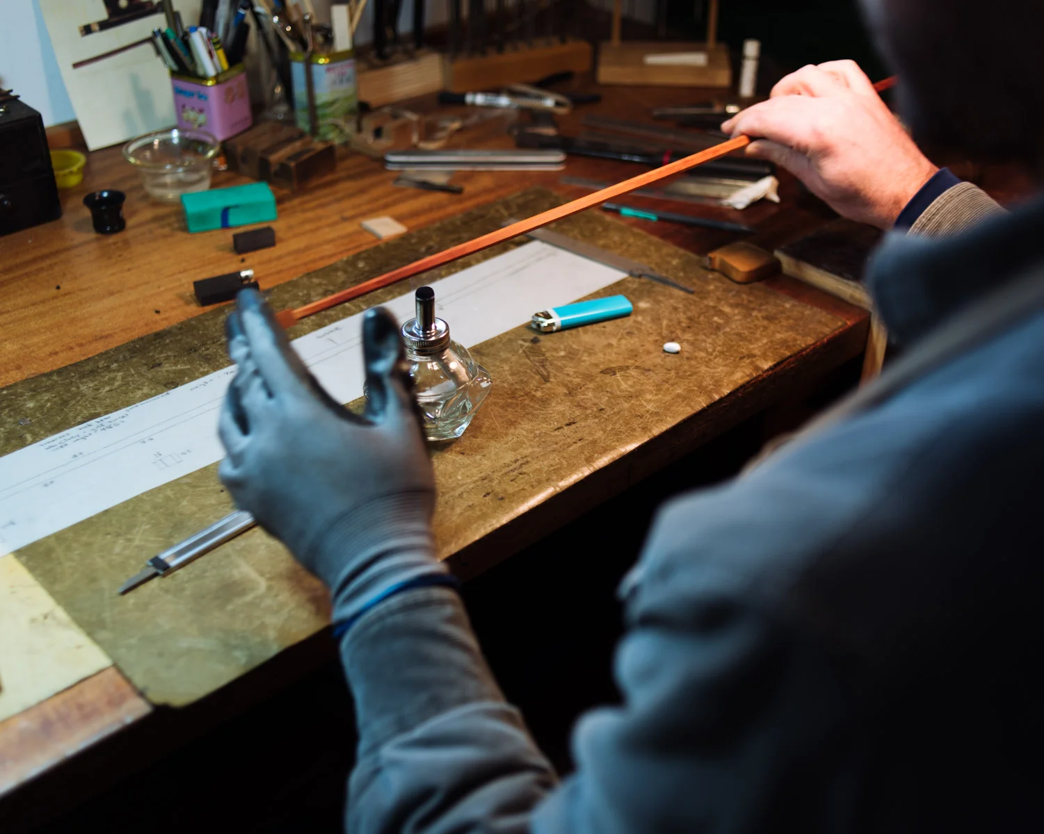 Jacob uses an alcohol flame to heat the wood, making it pliable