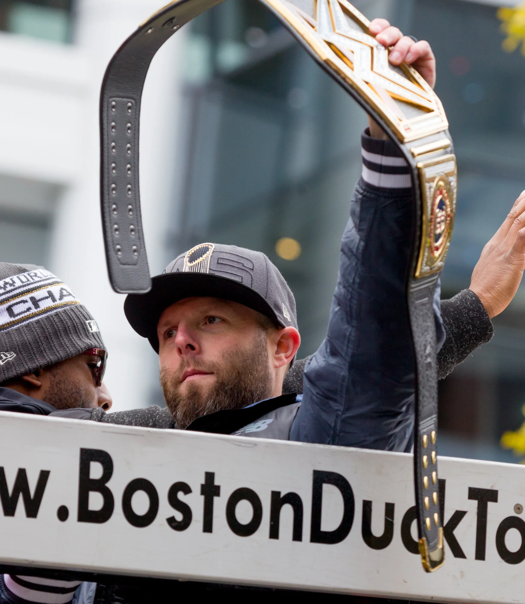 Dustin Pedroia with some odd WWE wrestling belt with the Red Sox logo on it.