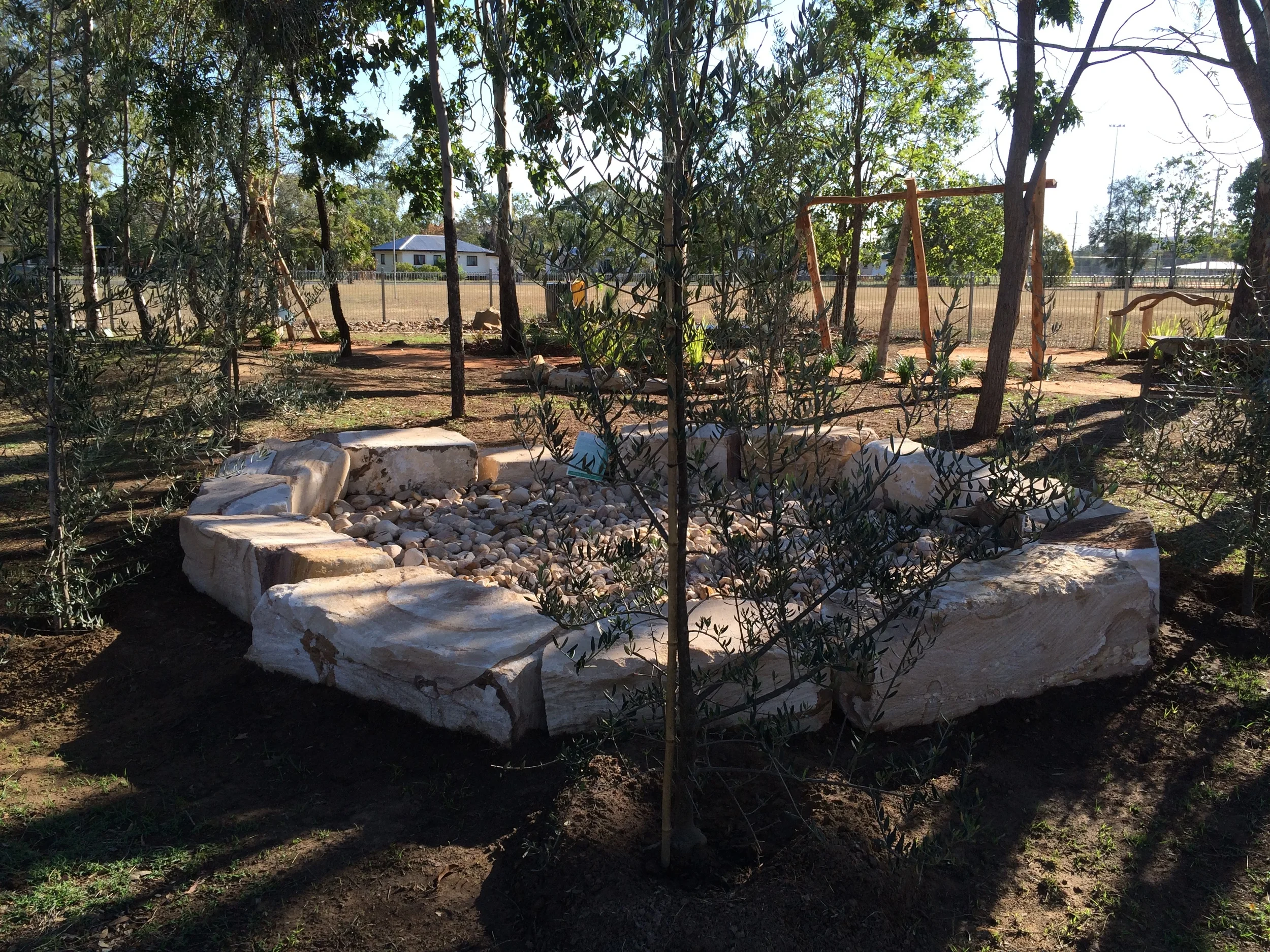 Sandstone meeting circle with a ring of Olive trees