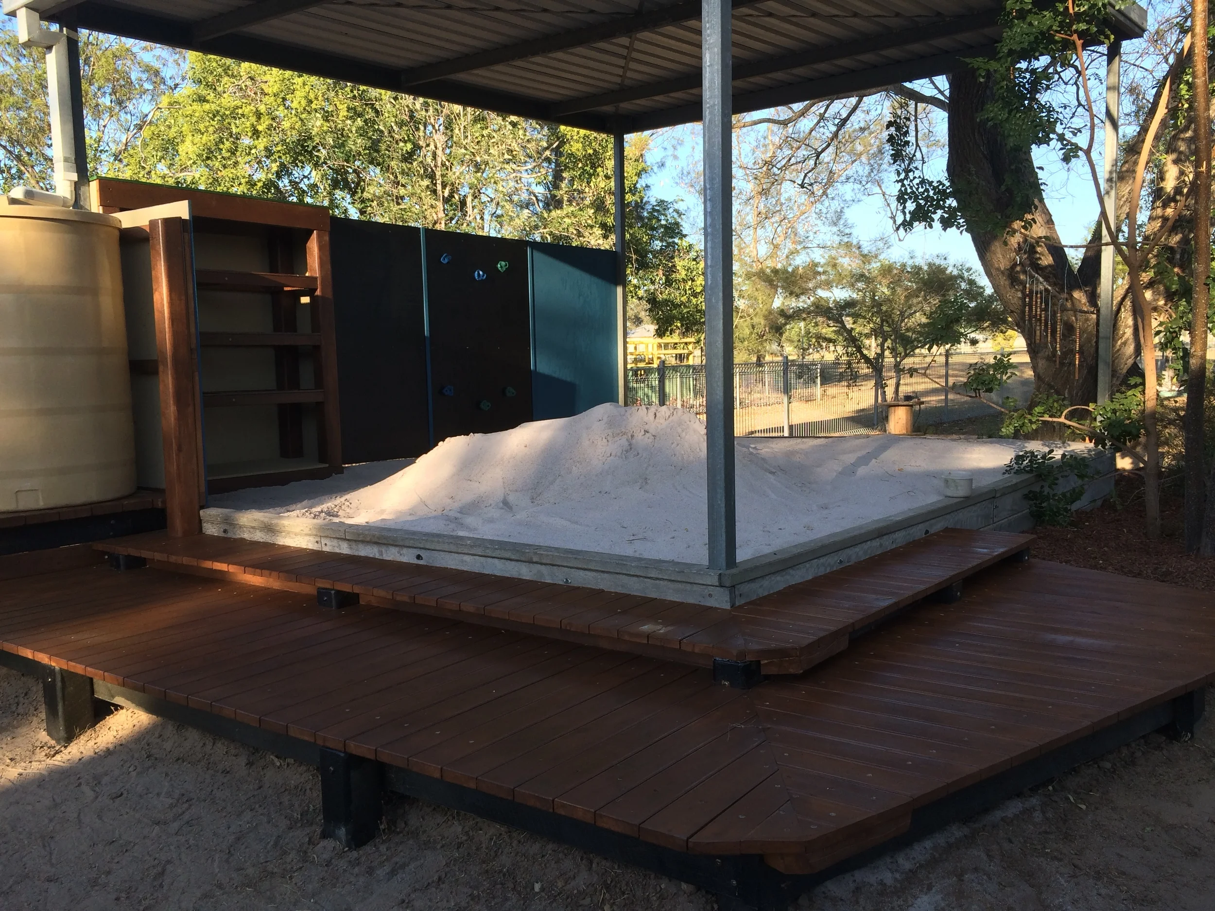 New deck,storage, mini climb wall, blackboards and water tank update the topped up sandpit