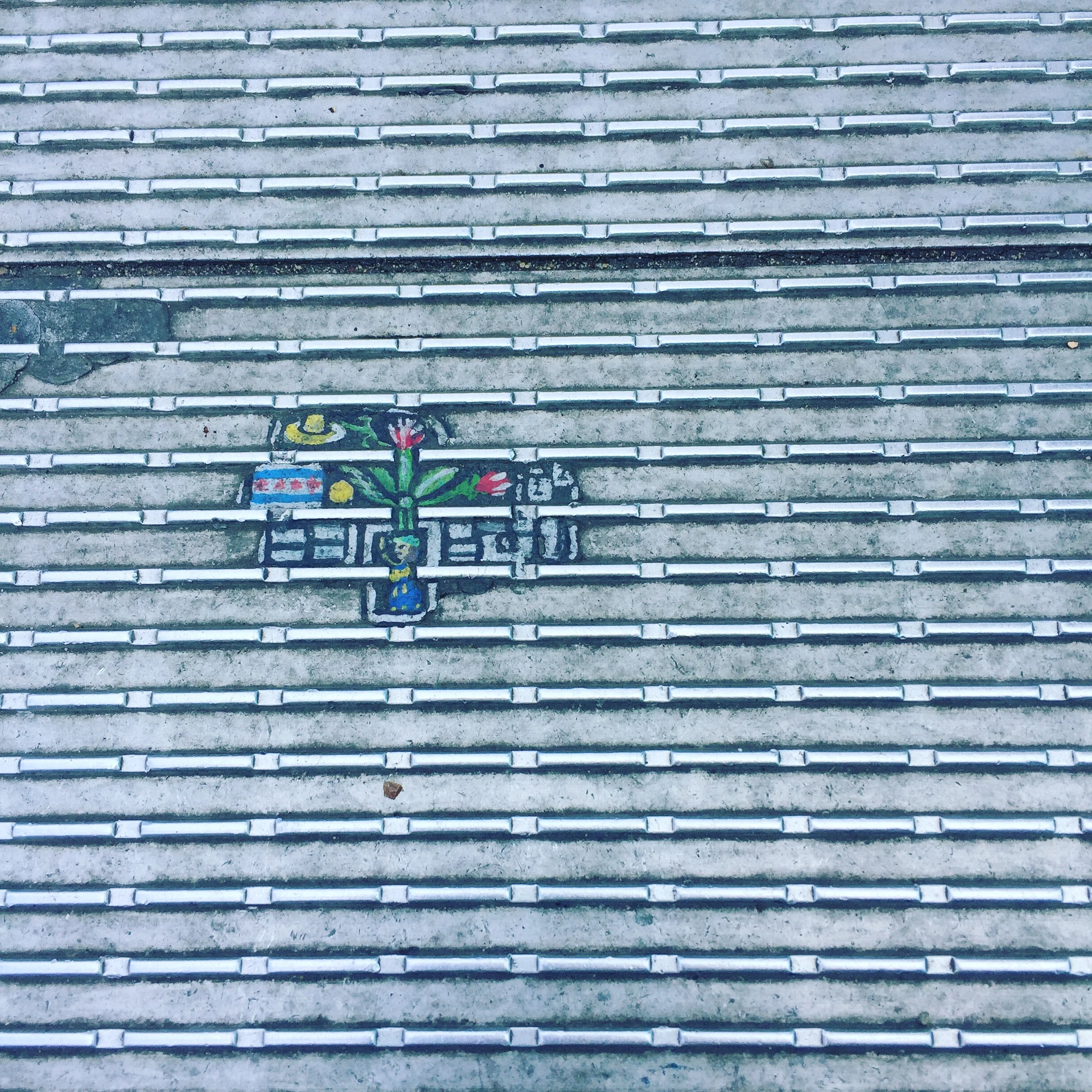 Artwork on the Millennium bridge in London. NOT graffiti because the art is on a gum wad.