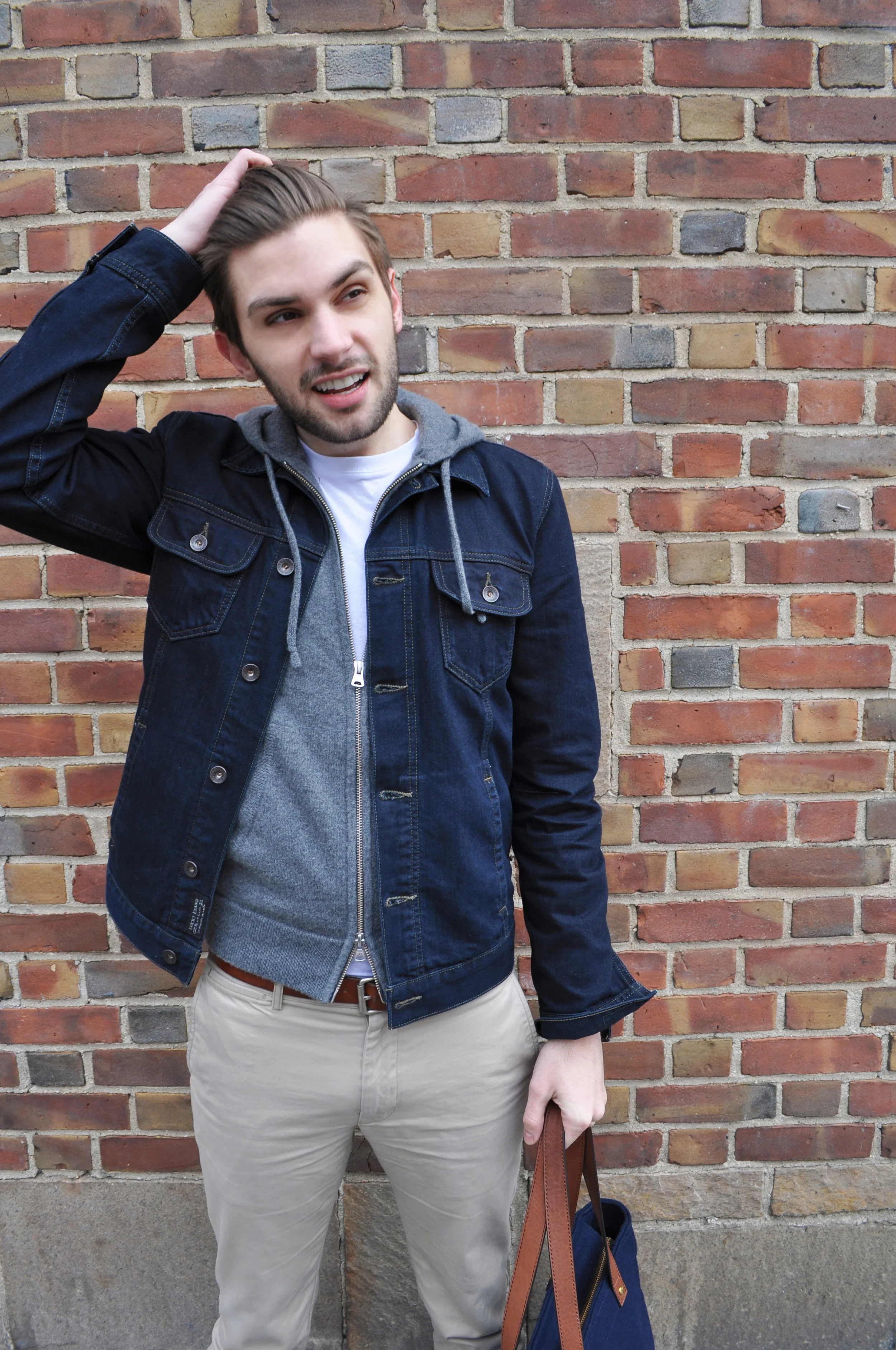 You can't go wrong with the classics: a denim jacket, a white tee and chinos. They're grounded in utility and have been around since the 50's. The basic tee was standard issue Army underwear till James Dean came along and rocked it with a pair of denim and a serious amount of machismo. Elvis and ranchers alike have worn denim jackets through the years and the chino is undeniably one of the most versatile pieces in a man's wardrobe. They're iconic and yet completely open to your personal style. So, how would you rock these classics? ...P.s. We shot in the West Village for this one because I am obsessed with a coffee shop down there. Cafe Minerva is an under-the-radar neighborhood coffee house that lets you forget about the big city as you submerge yourself in some of the city's best espresso. It's a great place to get some work done, have a sandwich or (my fav) split a $20 bottle of wine... Gotta hold on to quiet places like this in NYC. Photo Credit: Cristopher Arce Lucky Brand Denim Jacket / Club Monaco Cashmere Hoodie and Chinos / Dyer & Jenkins Tee / Banana Republic Sunglasses / Timex Watch / Ben Minkoff Bag