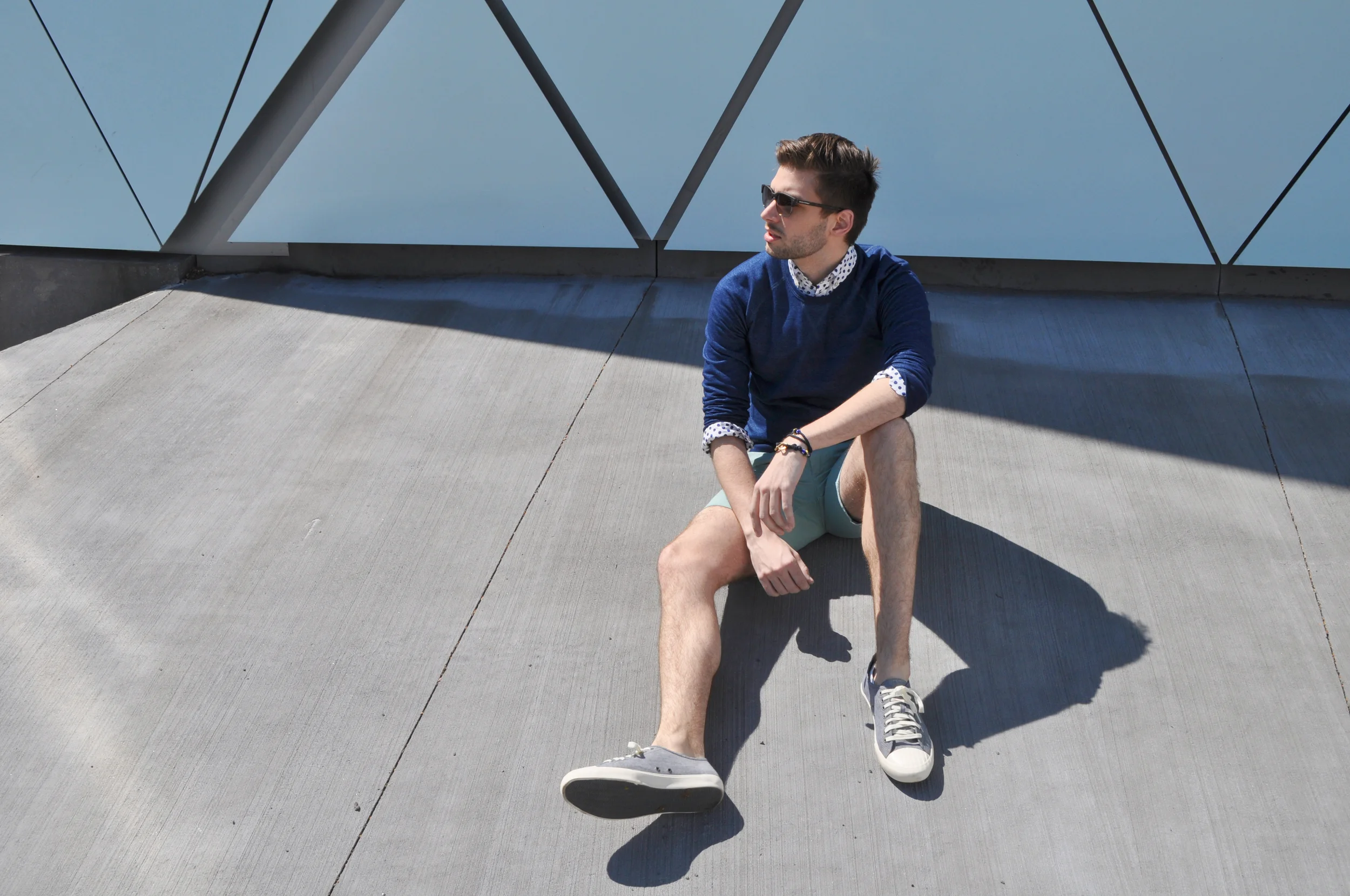 It's already starting to warm up in the city so I'm cooling down with some fresh blues and mint green. Pairing different hues from the same color family brings a level of sophistication but it's just so easy to do. Try some head to toe color and you might be surprised! This Indigo sweatshirt is a 'made in America' classic. Dyer & Jenkins are a couple of authentic craftsmen and they're taking working-man basics to the next level. Their natural Indigo crews, selvedge denim and iconic tees will outfit you in quality fabric that will stand the test of time. I added a bit of wit to the look with the polkadot shirt and finished it off with my Giles & Brother wrap bracelet. Staying cool never felt this easy. Photo credit: Michael Georgen Dyer & Jenkins Indigo crew / Joe Fresh shirt / J-Crew shorts / Banana Republic sunglasses and belt / Seavees sneakers / Giles & Brother bracelet