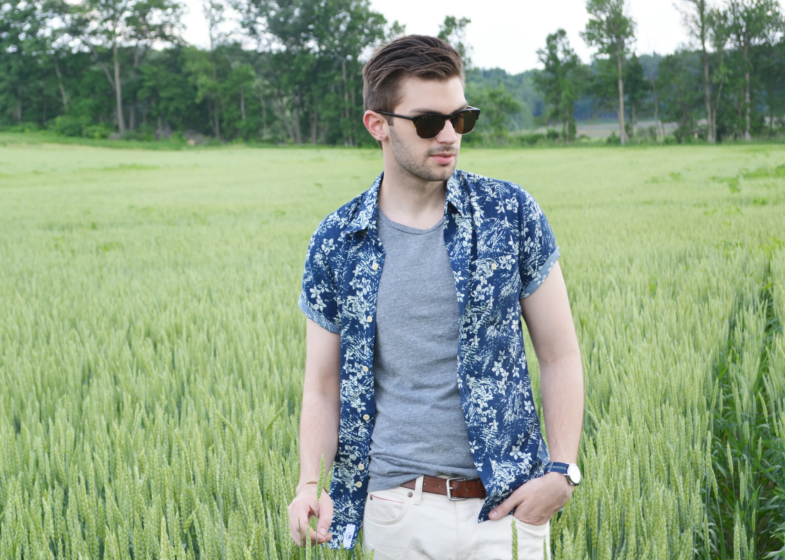 There is a huge wheat field behind my parent's farm and I couldn't help but shoot my wheat denim in the middle of the tall wheat. It just had to happen. It's so unbelievably peaceful and laid back here! I spent the afternoon mixing up some Moscow Mules (yes, I'm riding the MM train and I'm obsessed. If you haven't had a Moscow Mule in a copper cup, you have to try it.... I could write a whole post about them! Refreshing and perfect all year round.) and watched the sun set over the rolling fields. Thanks to sites like ASOS and GILT , I recently discovered a number of fantastic brands out of the UK. They're a nice break from the usual US mainstays and they often take bolder risks with print and trend. Bellfield makes clothing that is not only bold and fits amazingly well, but is pretty affordable. They say on their website they "enjoy designing creations that will empower the wearer to stand out from the crowd and exude effortless style". A floral print shirt definitely makes you stand out, but Bellfield did this print in all the right ways. It's easy and classic. Check out their full offering... and for my international peeps, let me know some other brands I need to check out!! Photo Credit: SW Bellfield shirt / The West is Dead t-shirt / J-Crew selvedge wheat denim / Timex watch / Club Monaco belt / Giles & Brother cuff