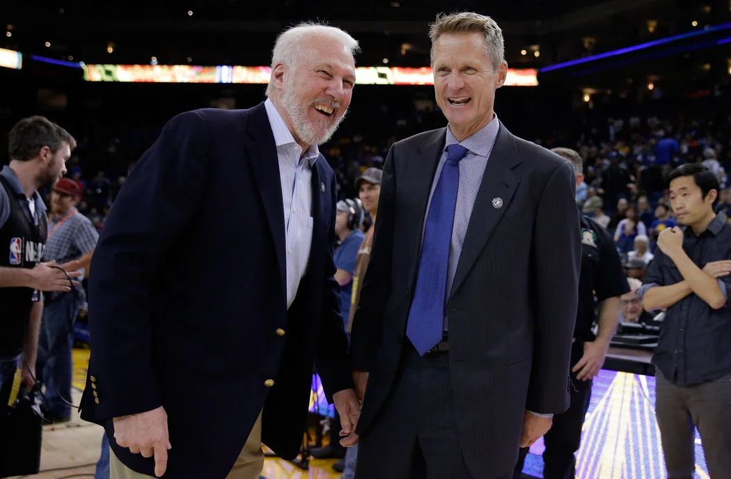 Popovich (L) and Kerr (R) share a lighthearted moment before a 2014 regular season game