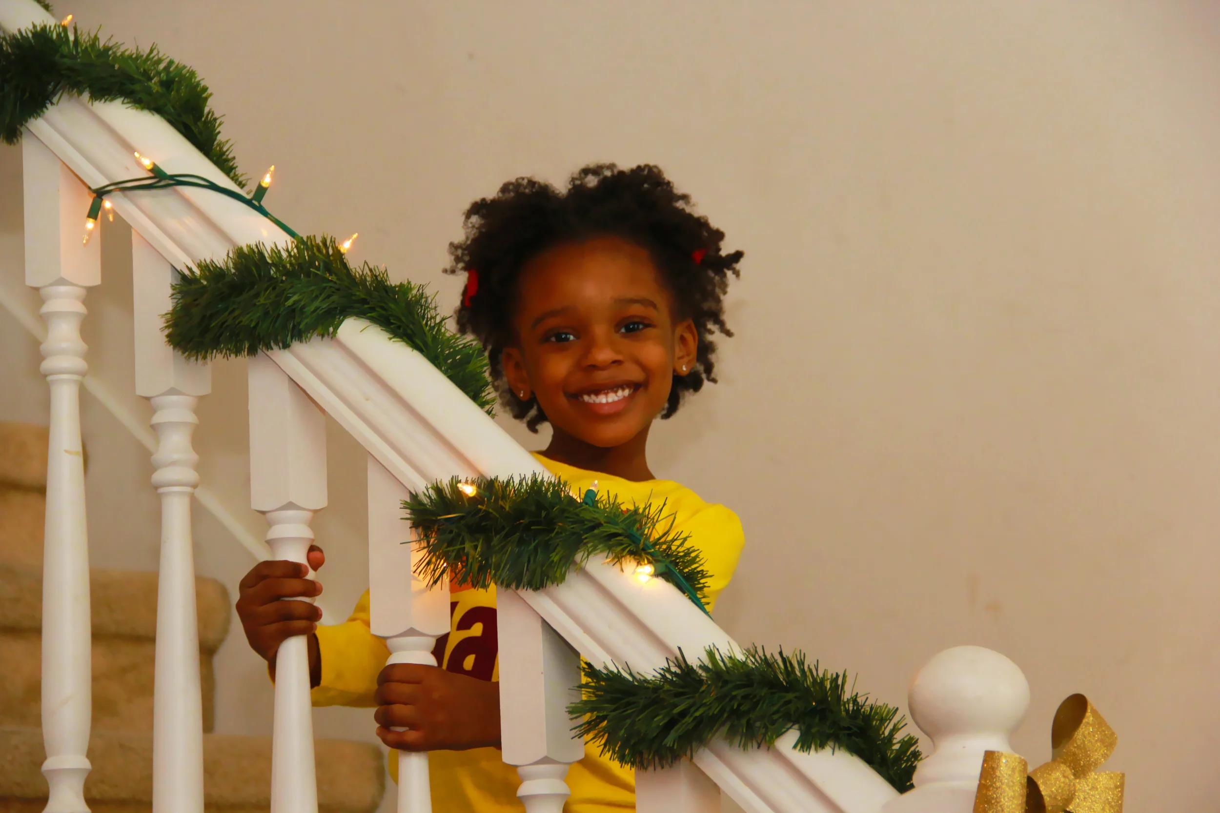 Young Girl on Staircase with Christmas Garland