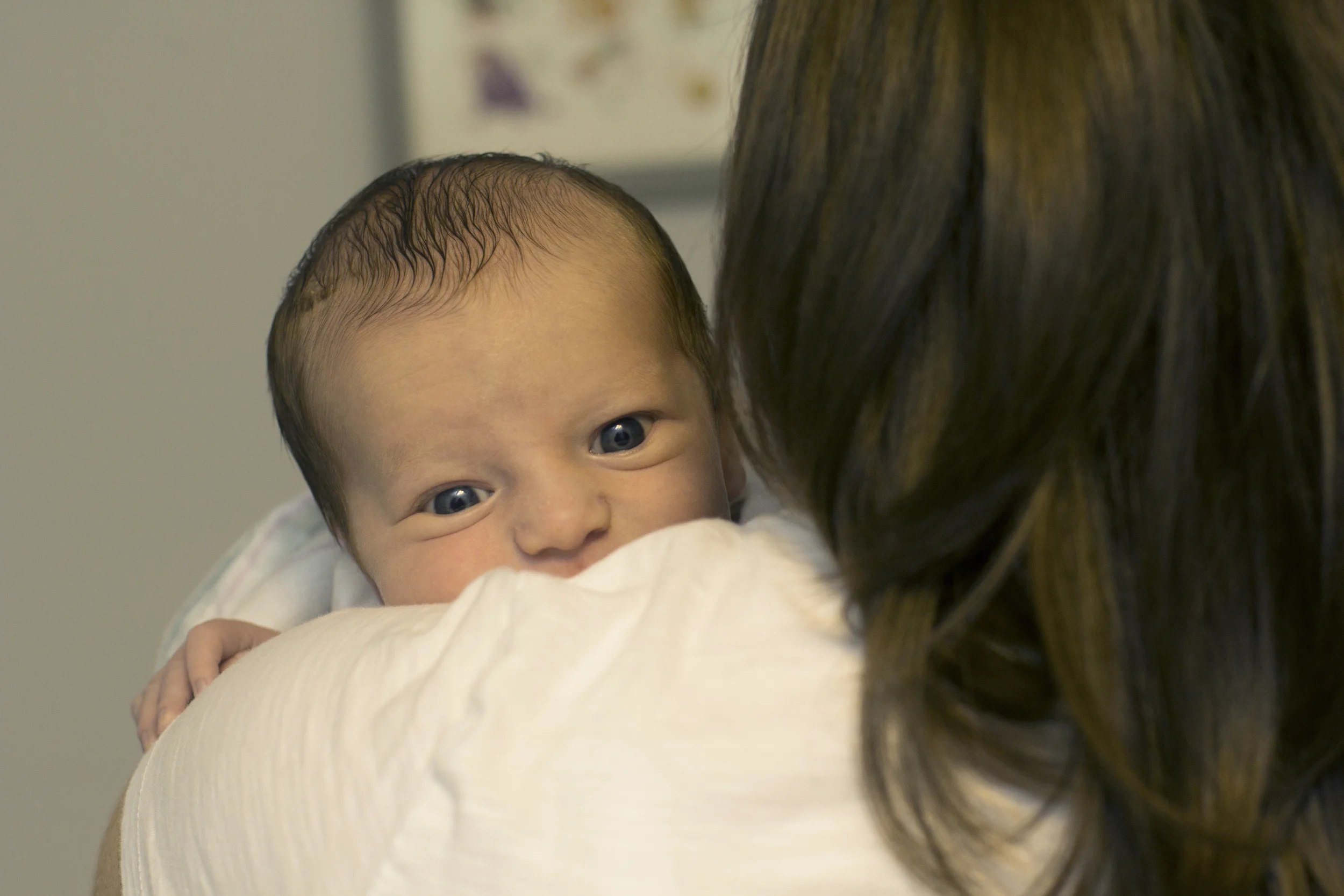 Newborn Baby Held By Mother