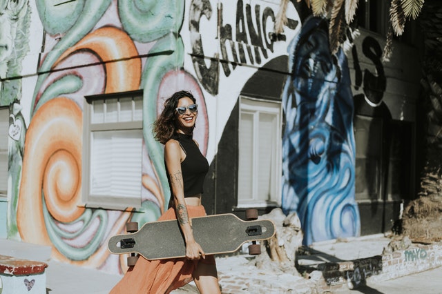 Woman with skateboard and graffiti background.jpeg
