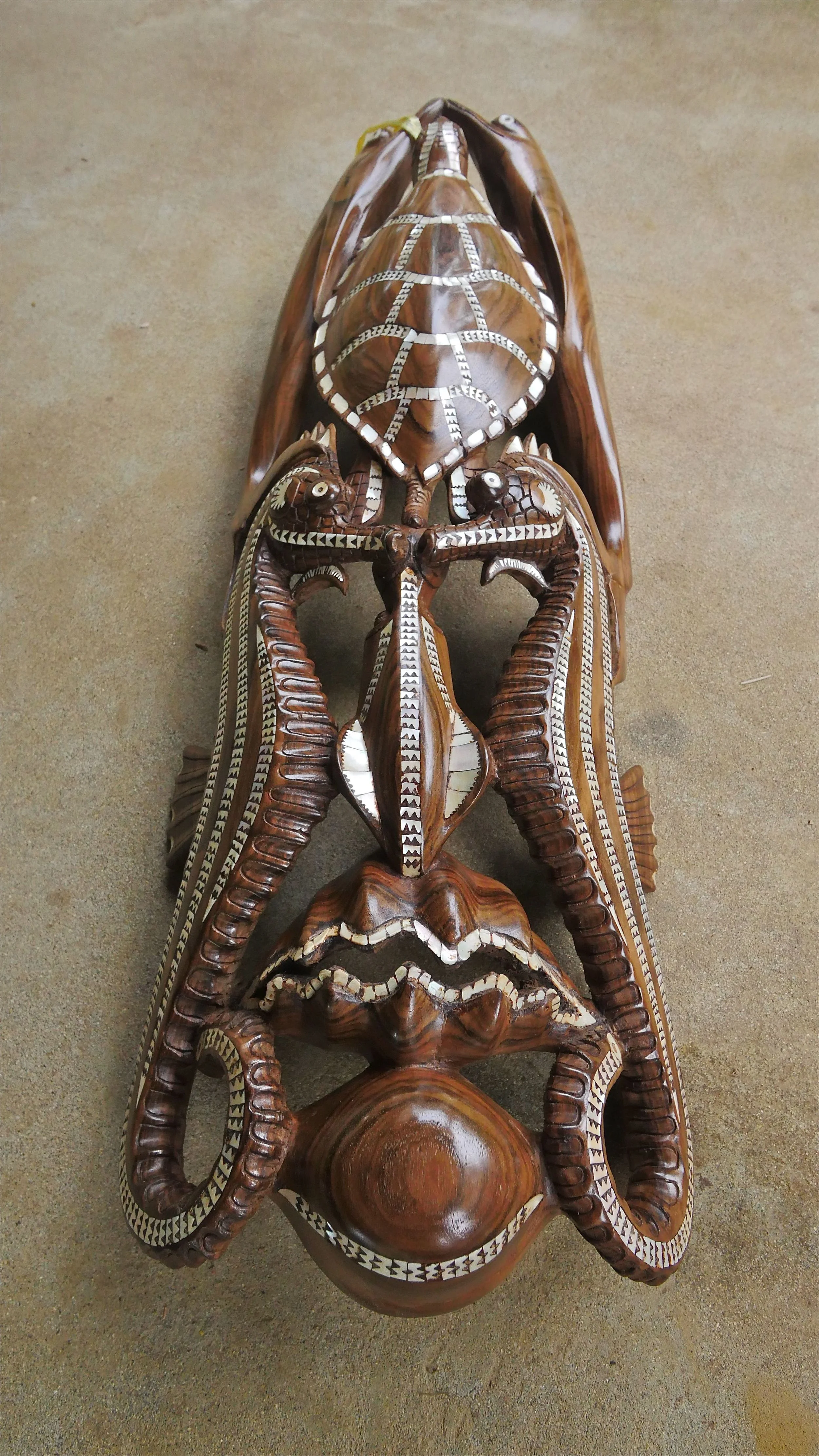 One of Maloe's artworks, made from local timber and nautilus shell. This mask represents the 'Spirit of Solomons' and is currently still for sale