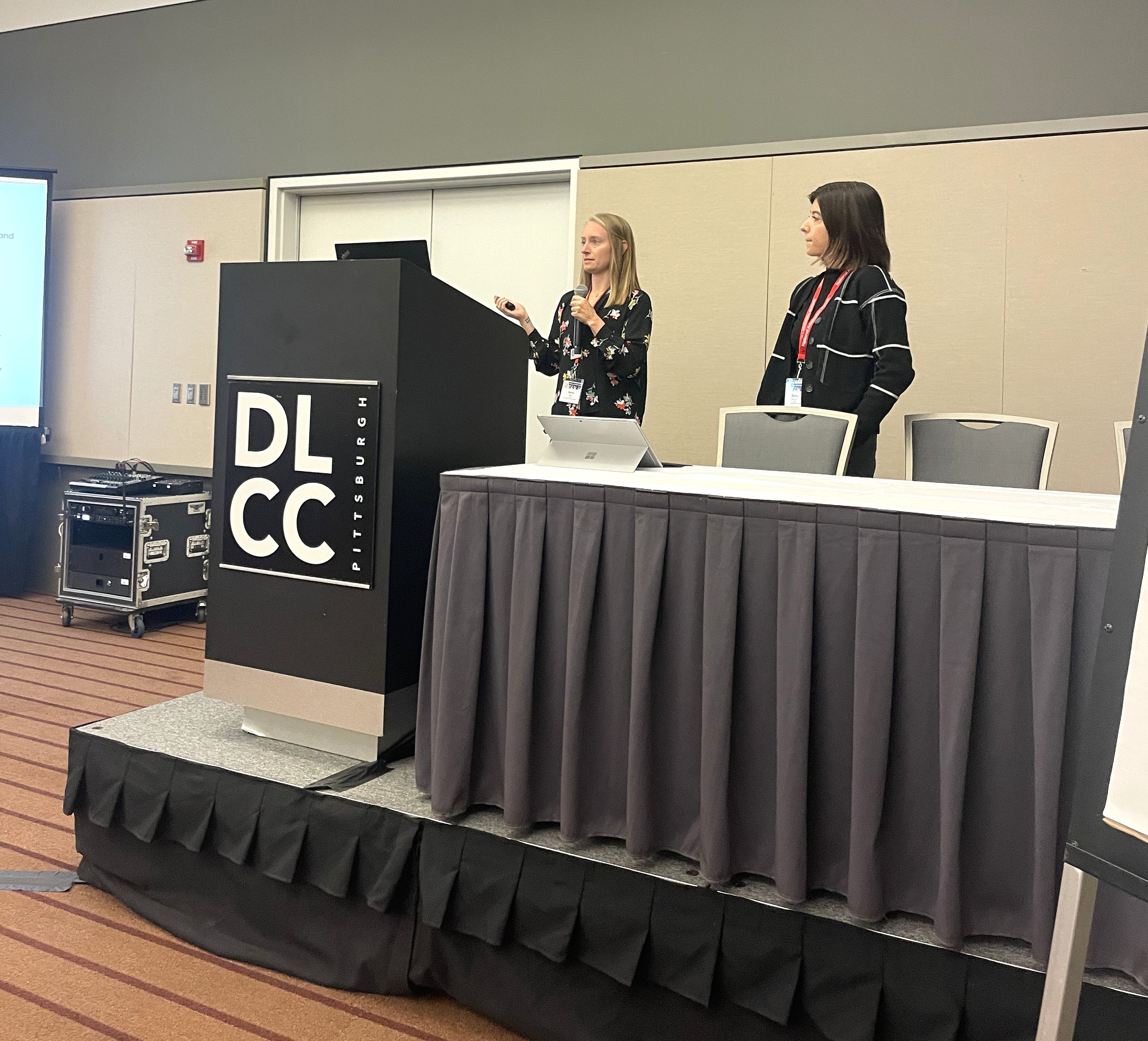Rachel Meier and Shelby de Jongh presenting at a conference.