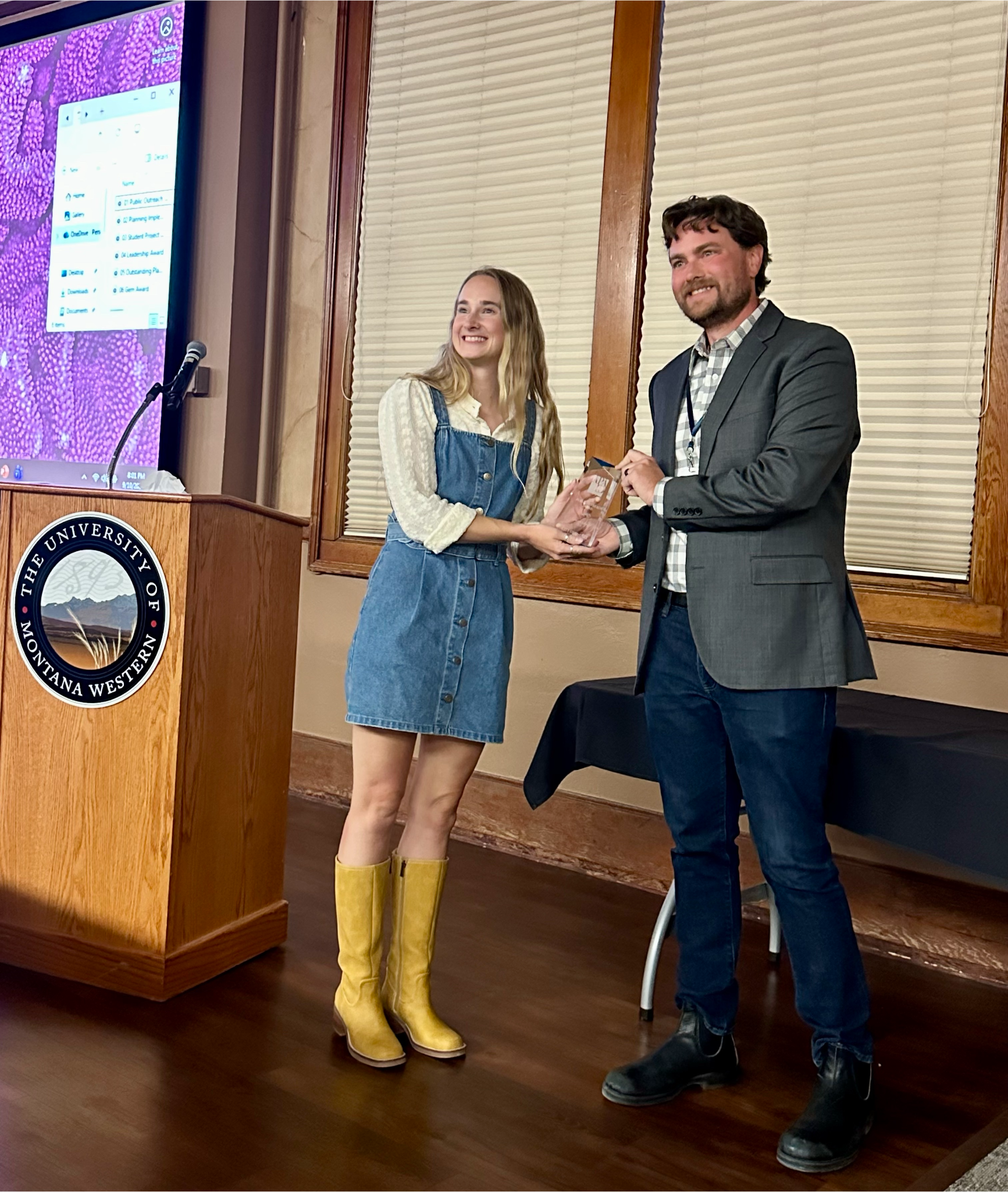 A woman and man accepting an award on behalf of the City of McCall.