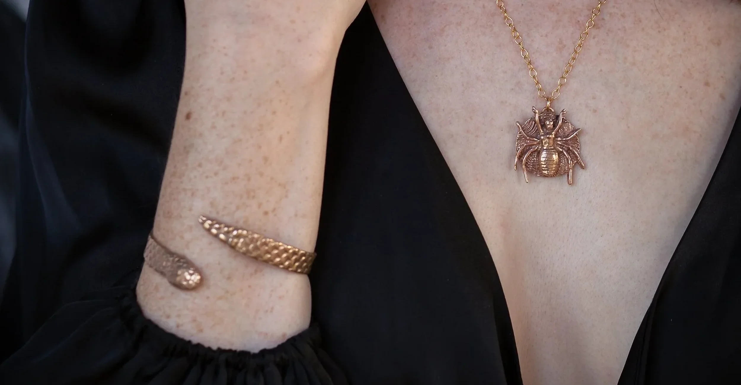 Snake bracelet and spider woman necklace.