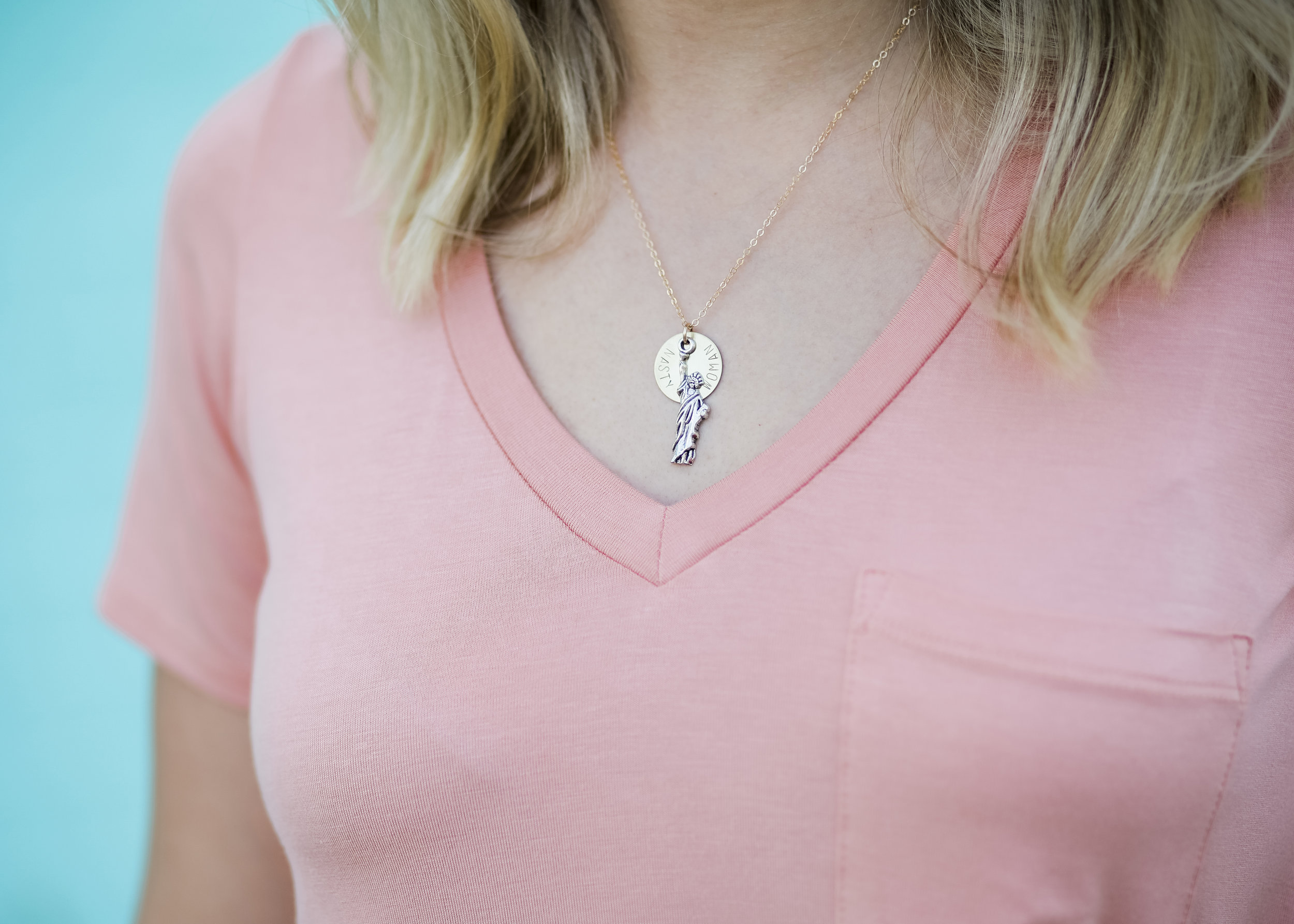 Nasty Woman Statue of Liberty Necklace and peach top from Maddox