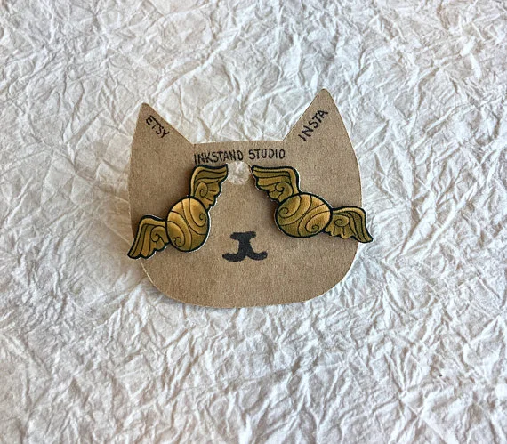 Golden Snitch Stud Earrings by InkStandStudio Everyone has a Harry Potter fan in their life. I got these for the lil Hermoine in mine. Get them here.