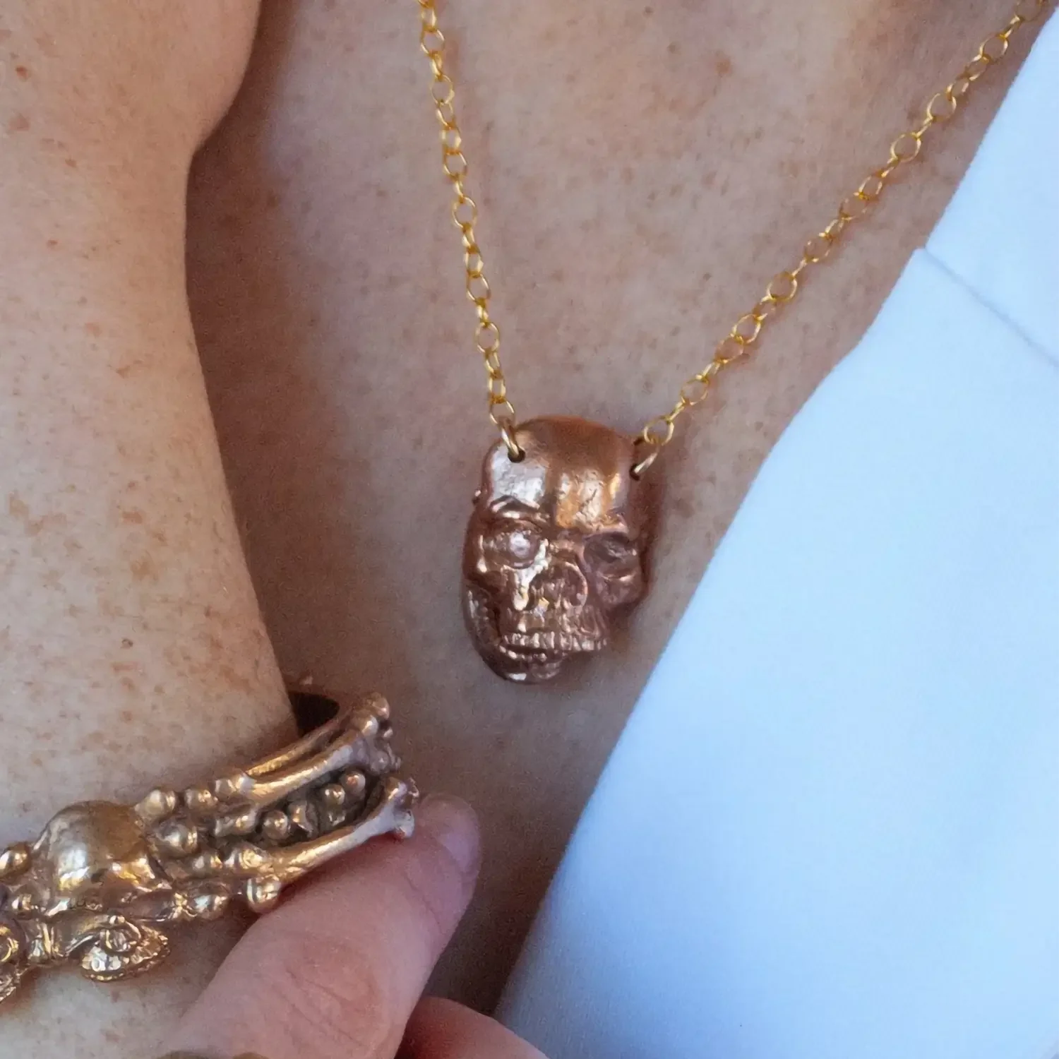 Skull necklace with mobile jaw made from cast bronze