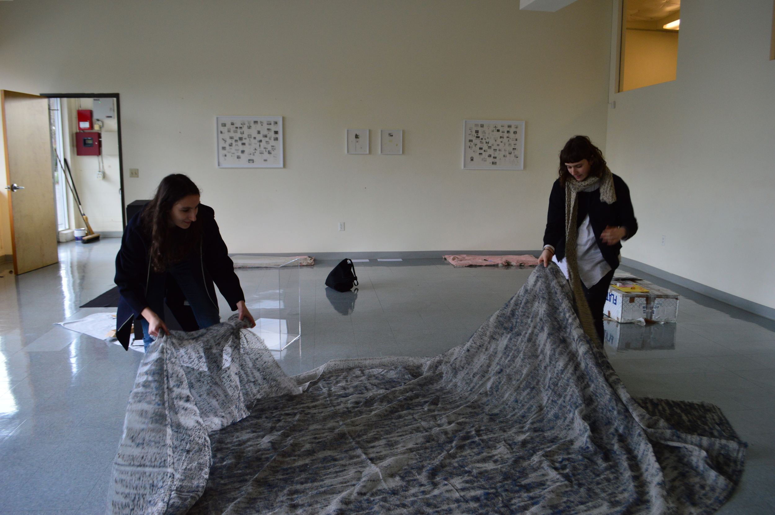 “Raw coordinators Lucy Weisner ‘16 and Jade Novarino ‘16 set up a piece of carpeting thats been picked apart by hand, revealing its fibrous skeleton.”